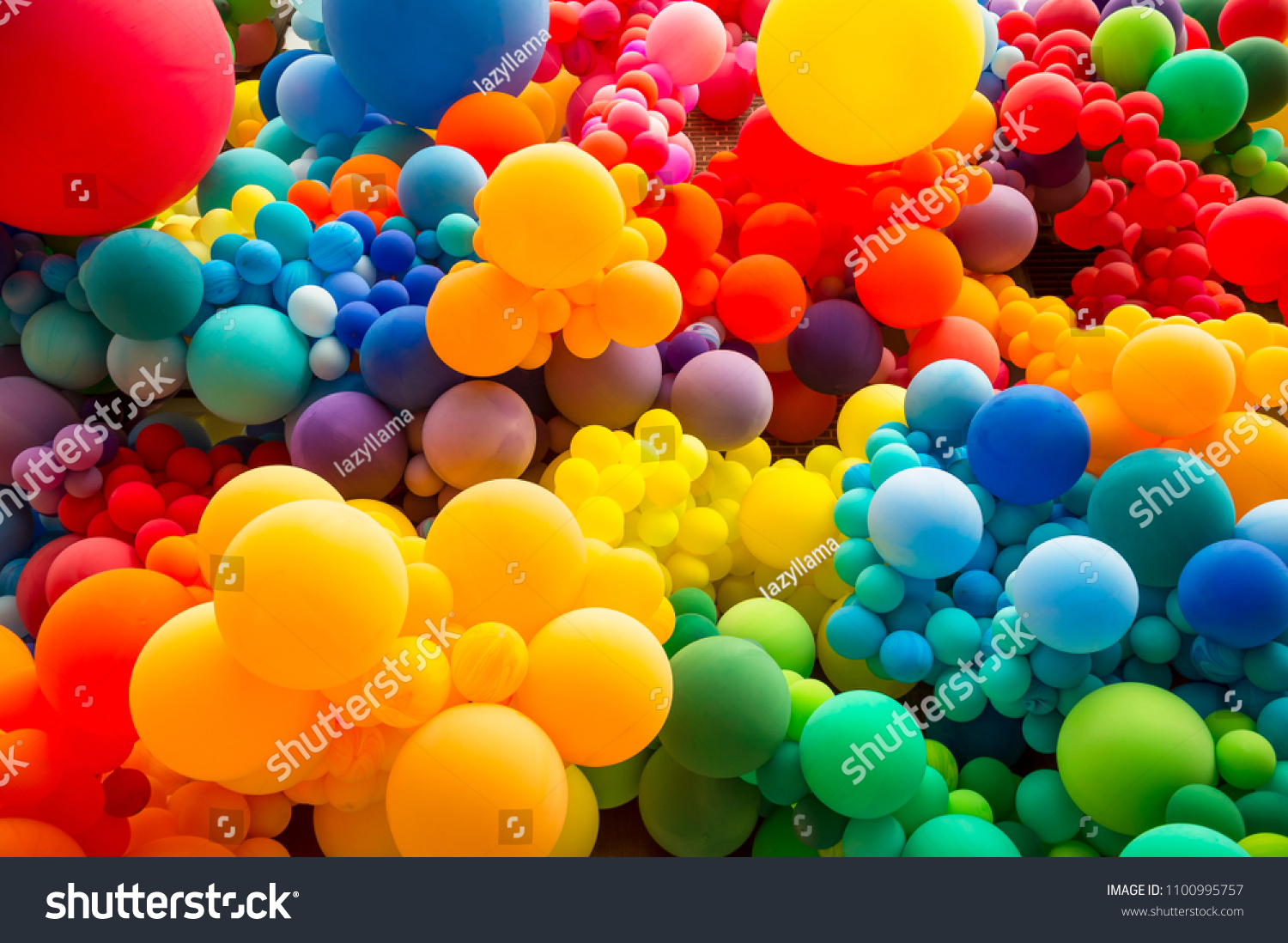 Bright abstract background of jumble of rainbow colored balloons celebrating gay pride #1100995757