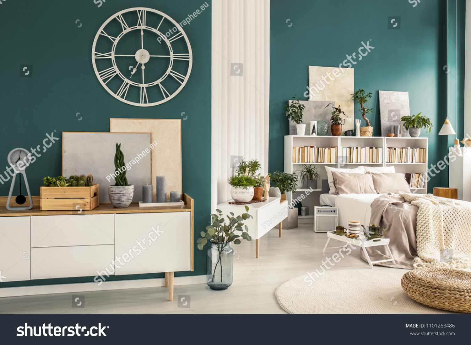 Modern studio apartment interior with cozy bedroom, white wooden furniture, designer decorations and plants #1101263486