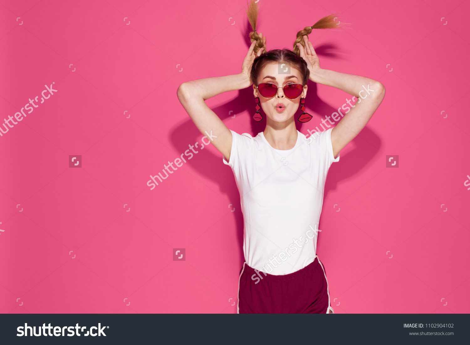 woman with glasses and with hands on hair                             #1102904102
