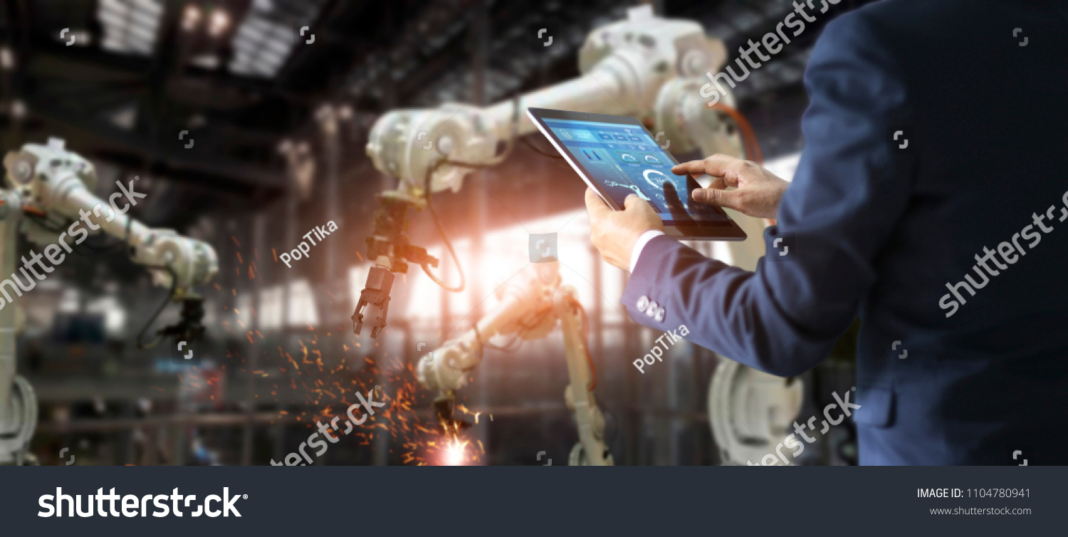 
Manager engineer check and control automation robot arms machine in intelligent factory industrial on real time monitoring system software. Welding robotics and digital manufacturing operation.  #1104780941