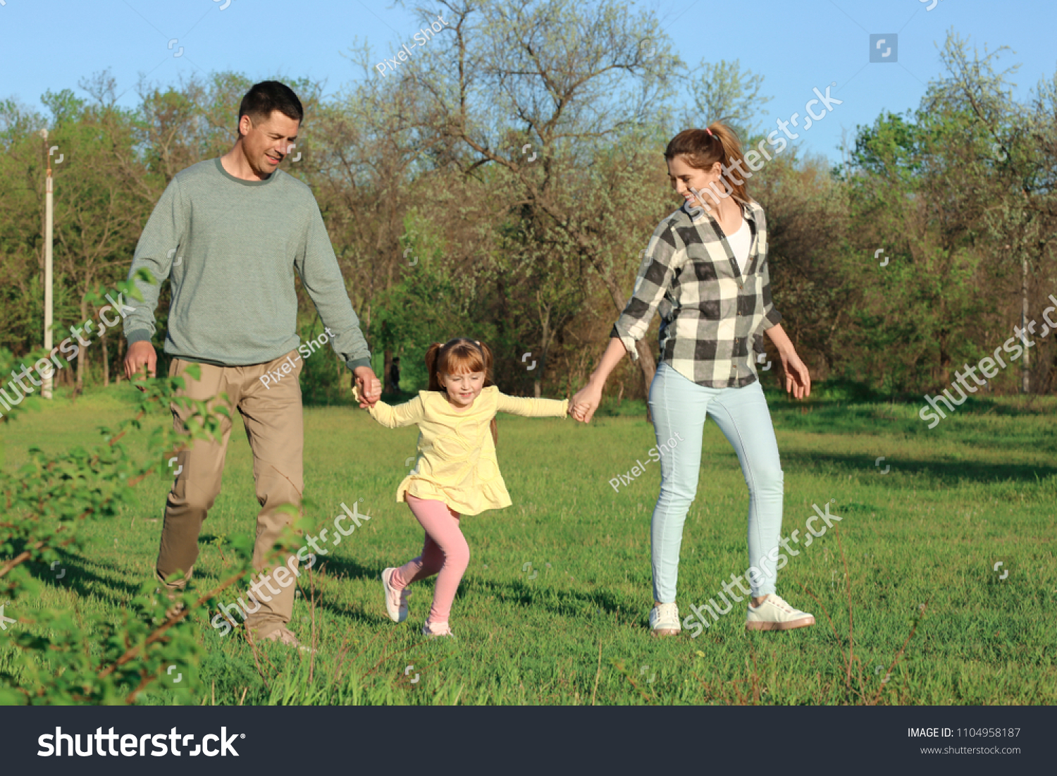 Happy family in park on sunny day #1104958187