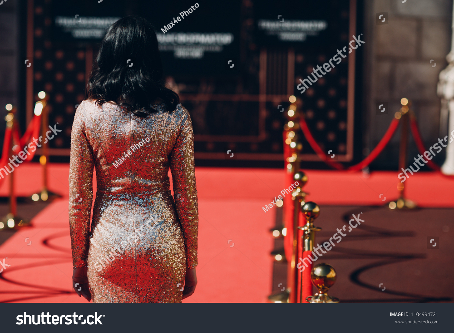 Woman in a luxurious dress on a red carpet #1104994721