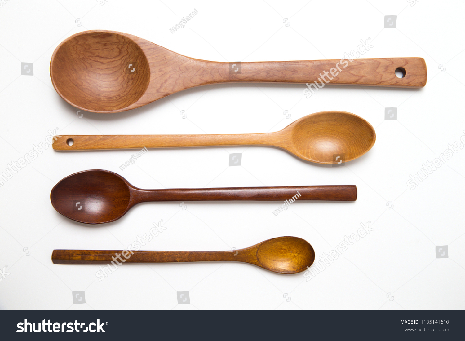 empty Spoons of different sizes with copy space. four wooden spoons on white background for text.
 #1105141610