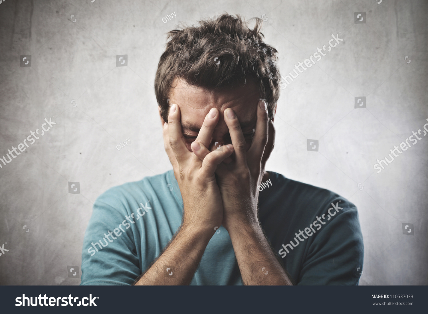 Desperate young man crying in his hands #110537033