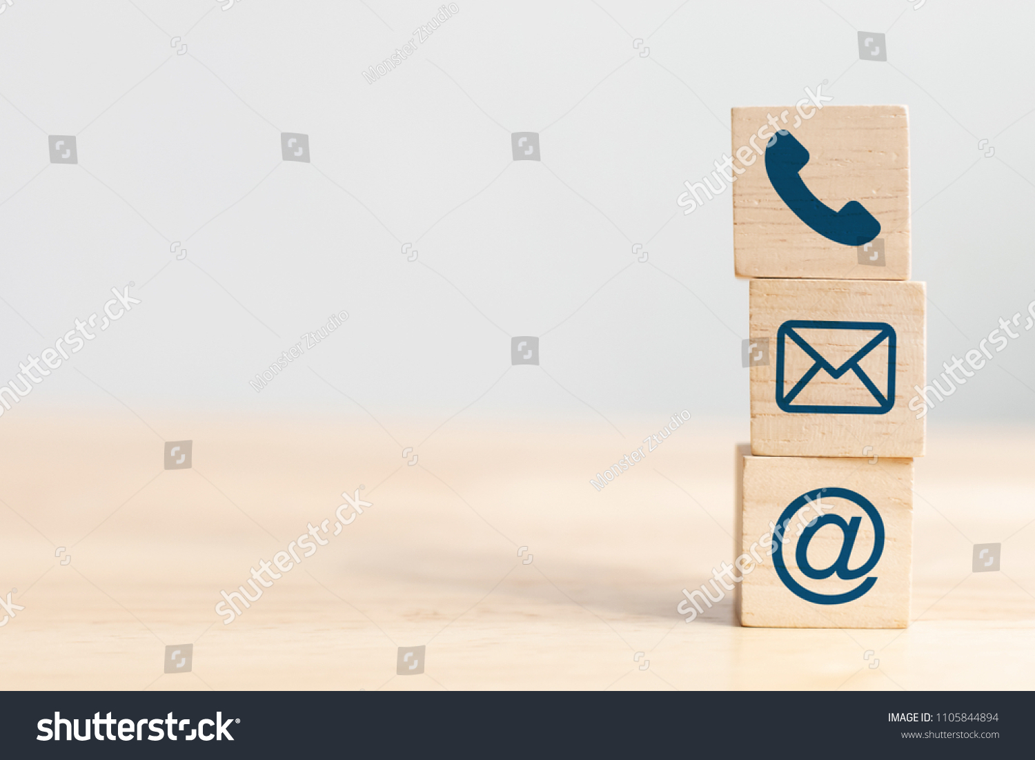 Wooden block cube symbol telephone, email, address. Website page contact us or e-mail marketing concept #1105844894