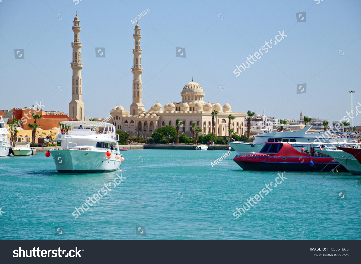 Seascape with motor yachts in marina. View of mosque  in the  background. Hurghada, Egypt #1105861865