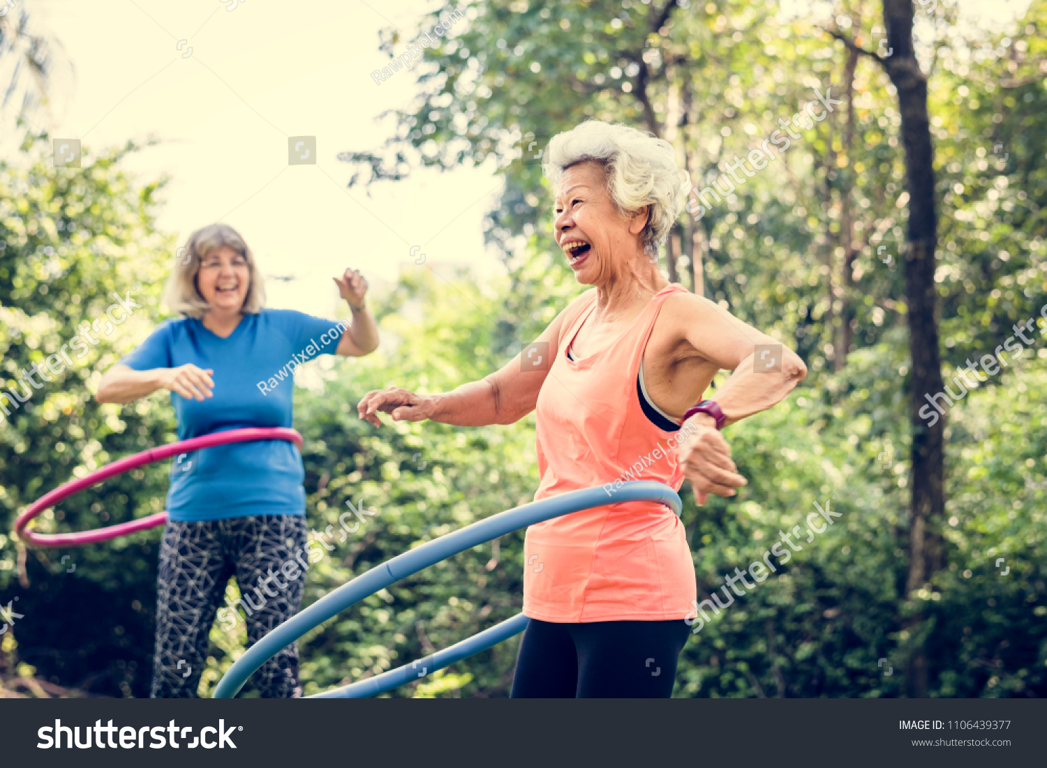Senior woman exercising with a hula hoop #1106439377