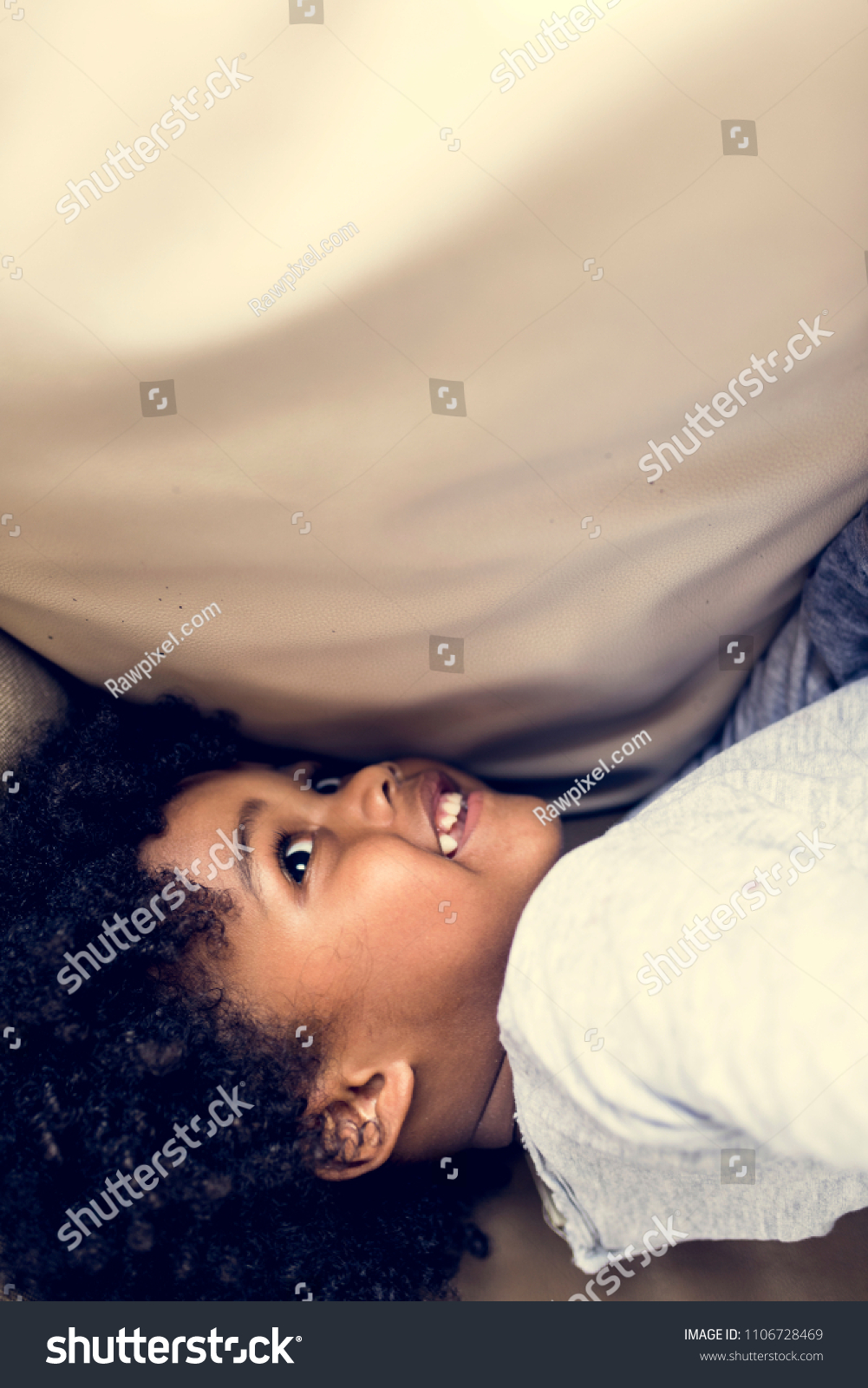 Little kid under a duvet #1106728469