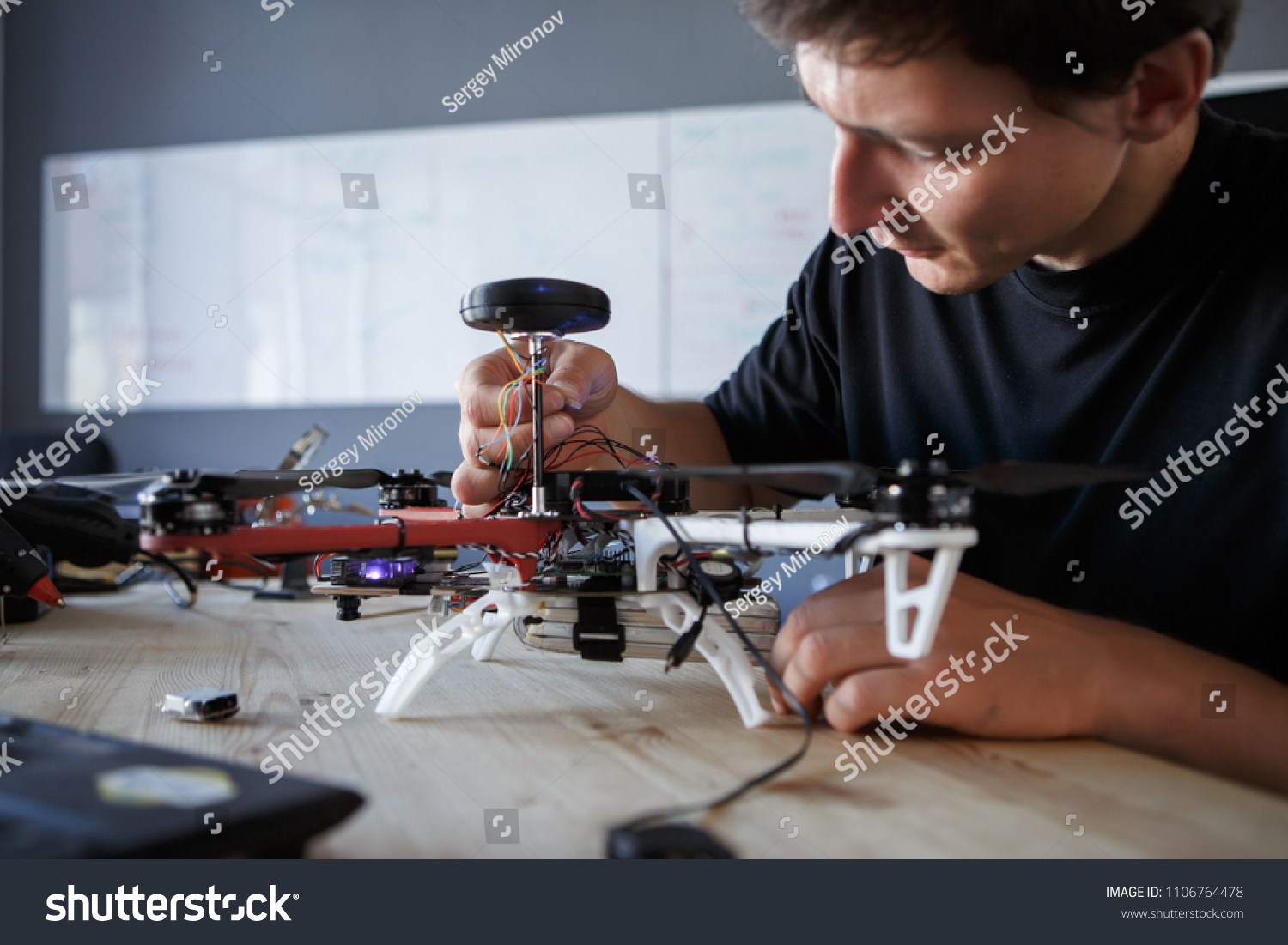 Photo of engineer fixing square copter at table #1106764478