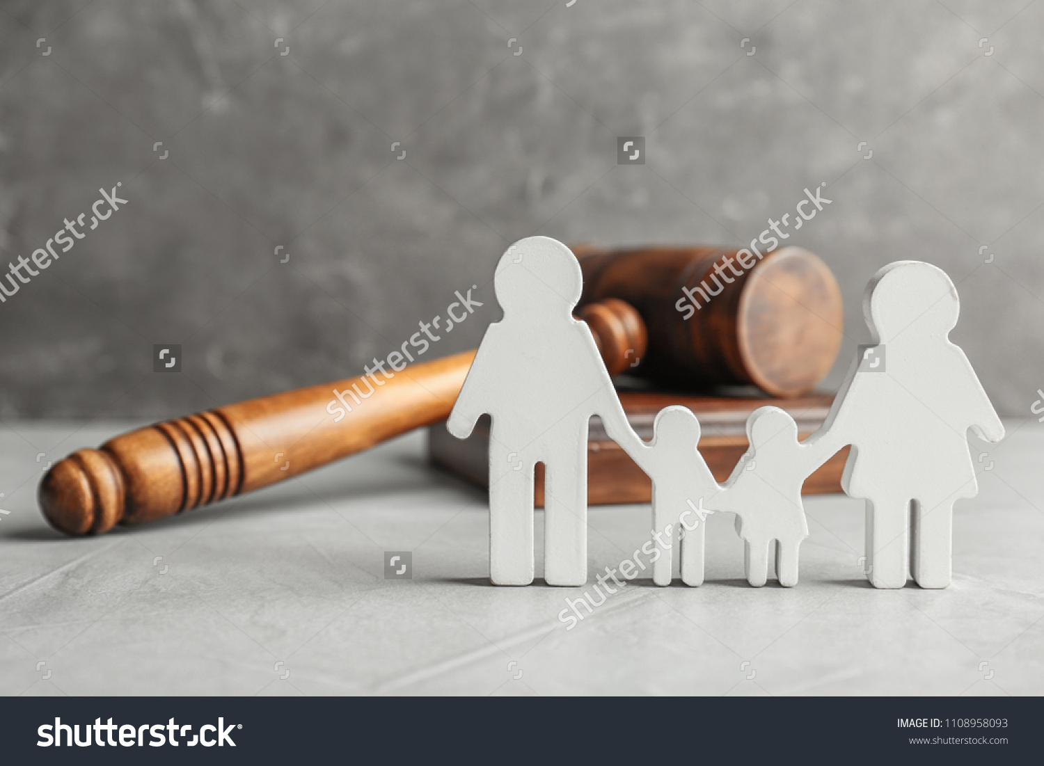 Family figure and gavel on table. Family law concept #1108958093