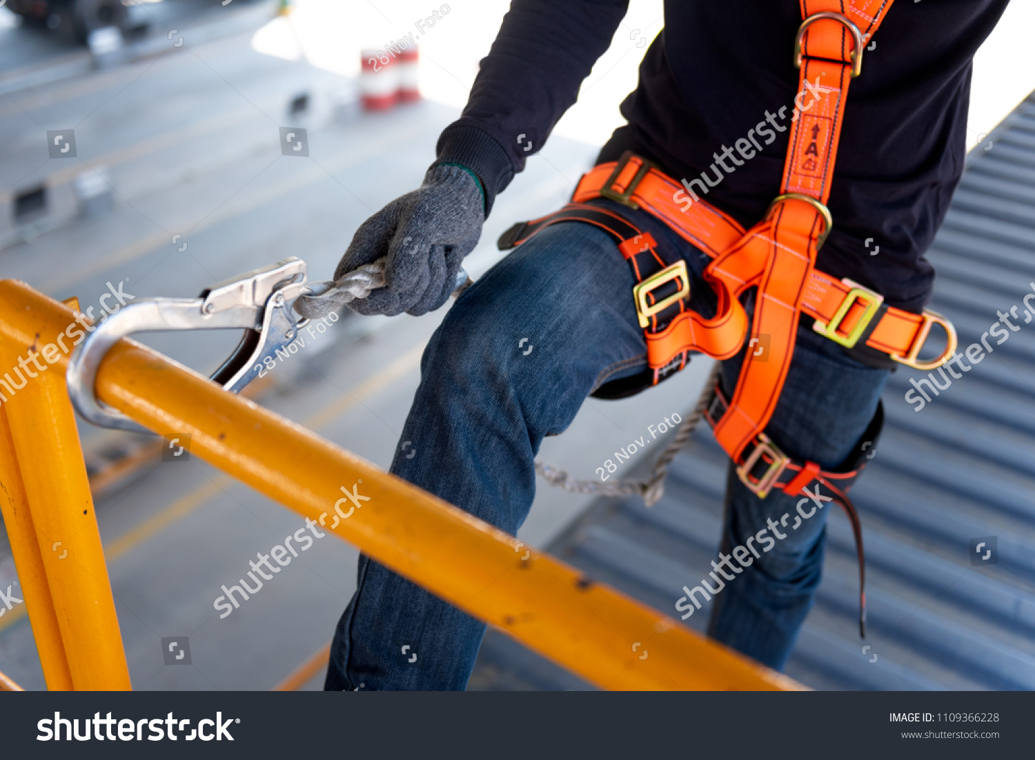 Construction worker use safety harness and safety line working on a new construction site project. #1109366228
