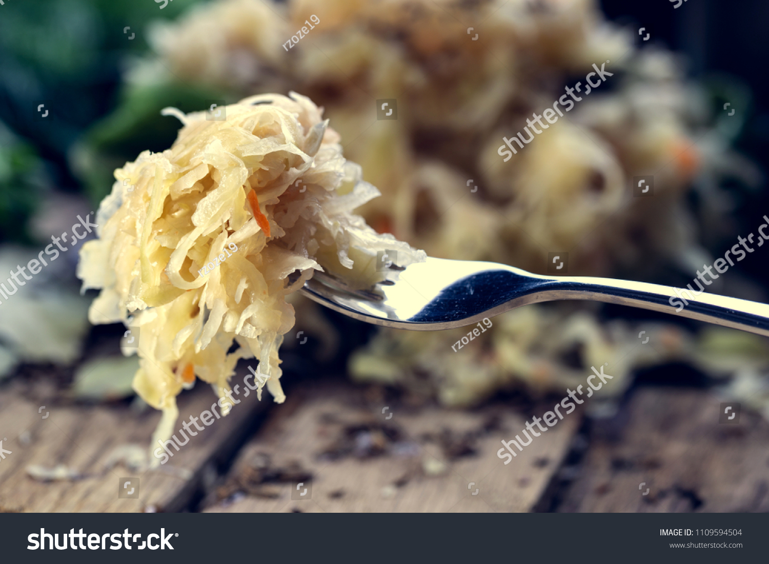 Sauerkraut on a fork with a shallow depth of field. Pickling cabbage at home. The best natural probiotic. #1109594504