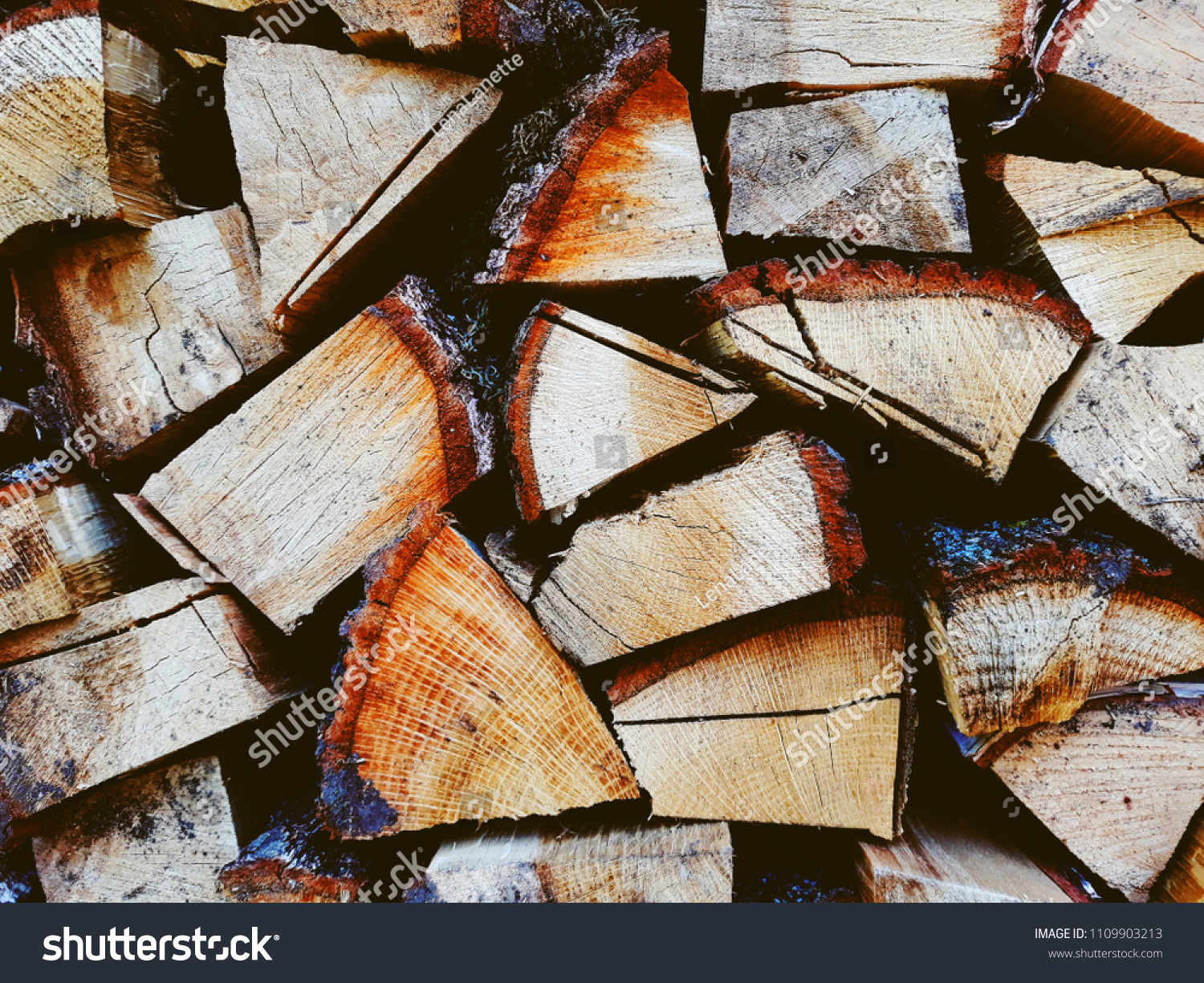 Firewood background, wall firewood, background of dry chopped firewood logs in a pile #1109903213