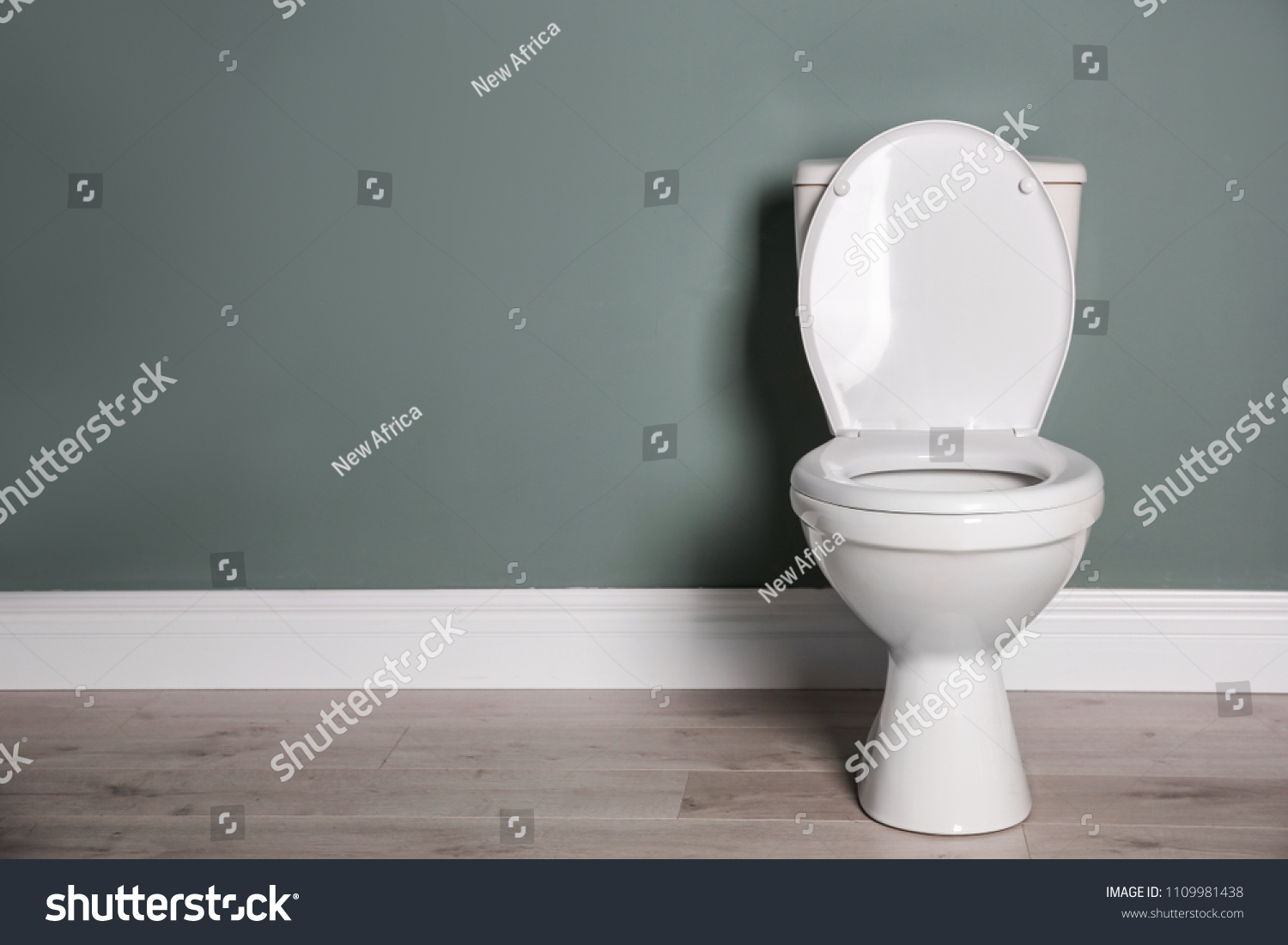 New ceramic toilet bowl near grey wall #1109981438