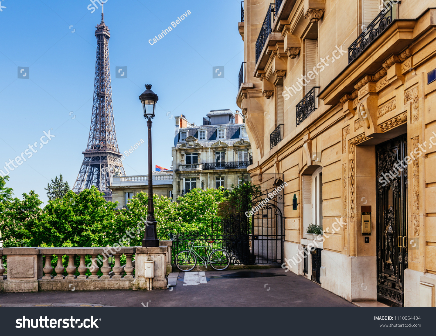 Cozy street with view of Paris Eiffel Tower in Paris, France. Eiffel Tower is one of the most iconic landmarks in Paris. Architecture and landmark of Paris #1110054404