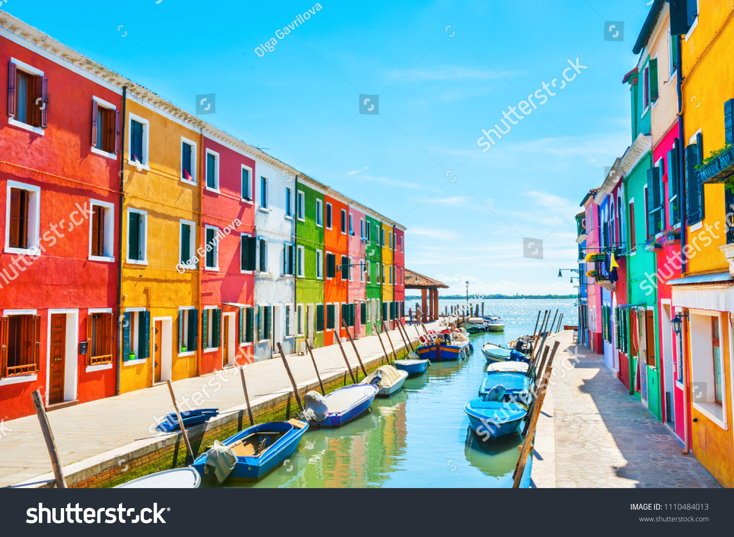 Scenic canal with colorful buildings in Burano island, Venice, Italy #1110484013