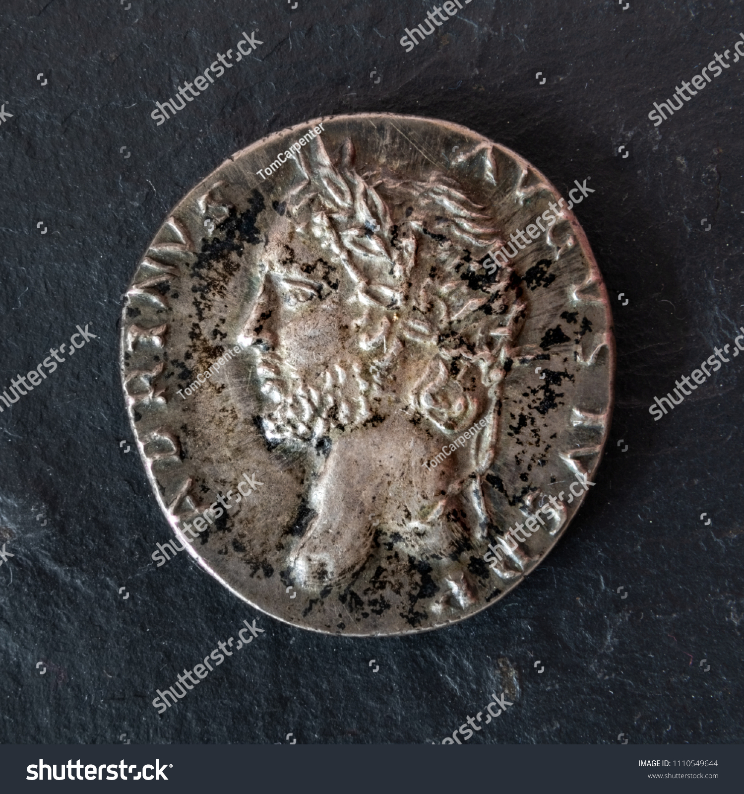Closeup photograph of a silver denarius coin of the Roman Emperor Hadrian. Obverse view. #1110549644