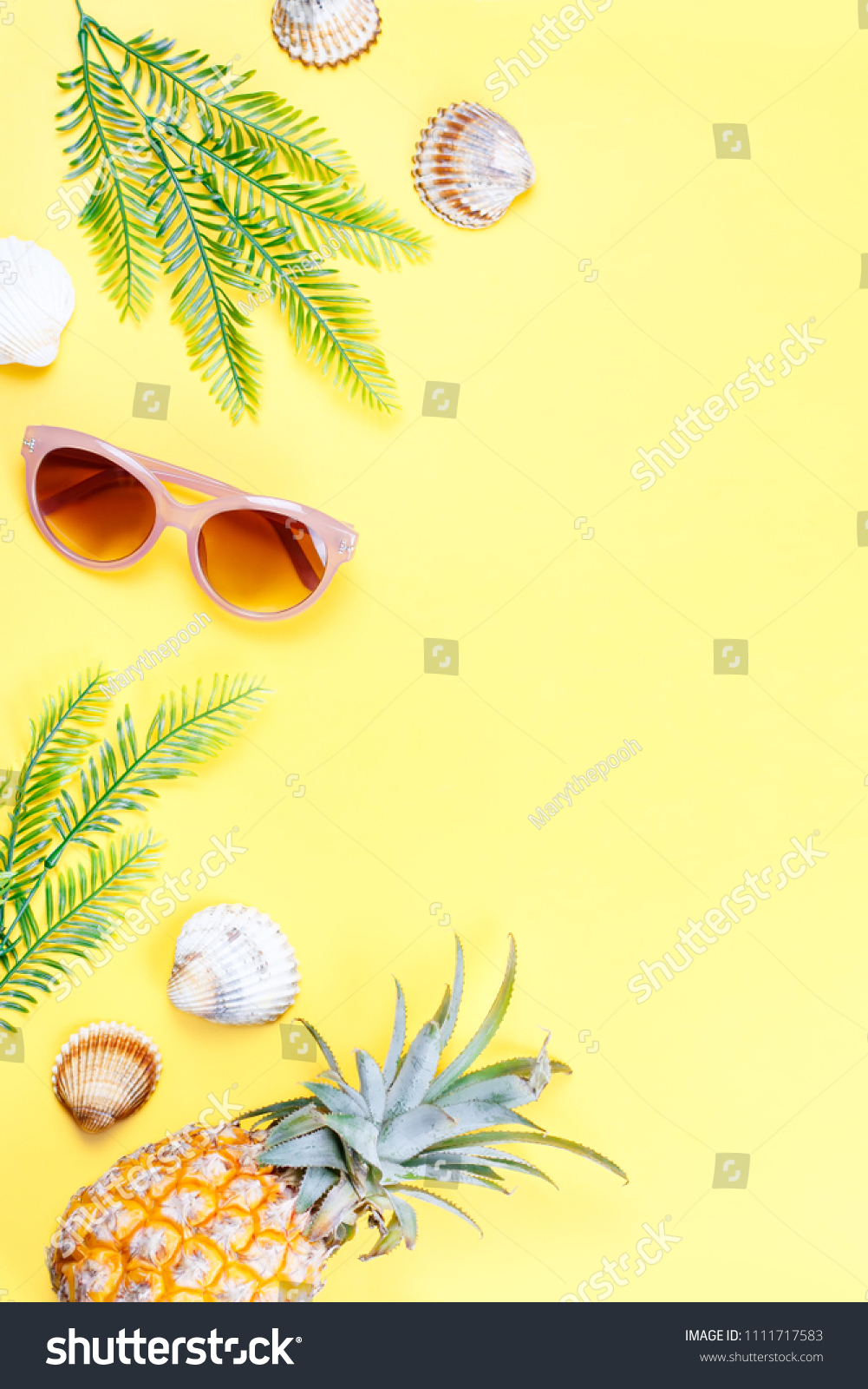 Tropical summer concept with woman fashion accessories, leaves and pineapple on yellow background. Flat lay, top view #1111717583