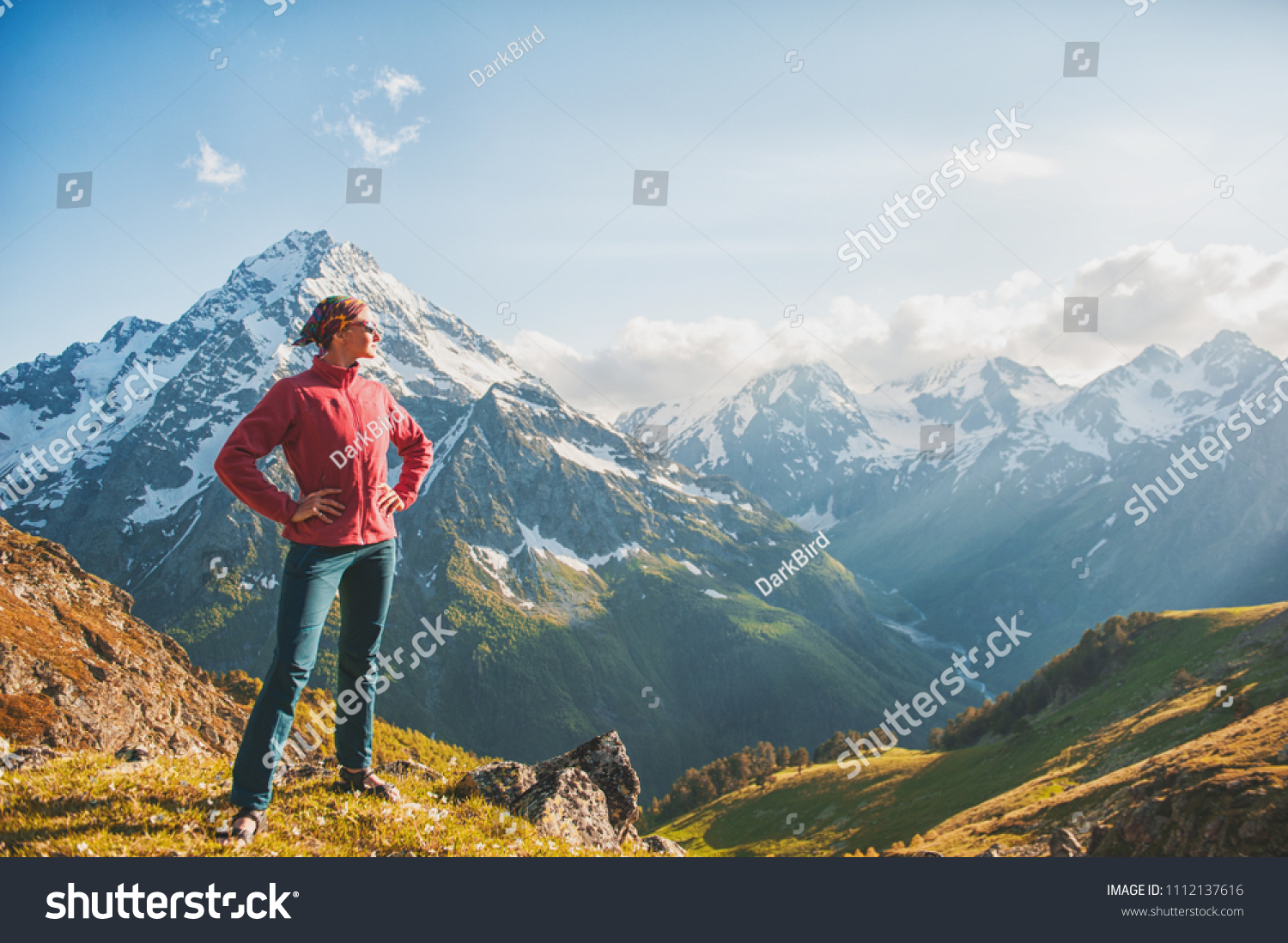 Woman hiker standing on the top of mountain outdoor #1112137616
