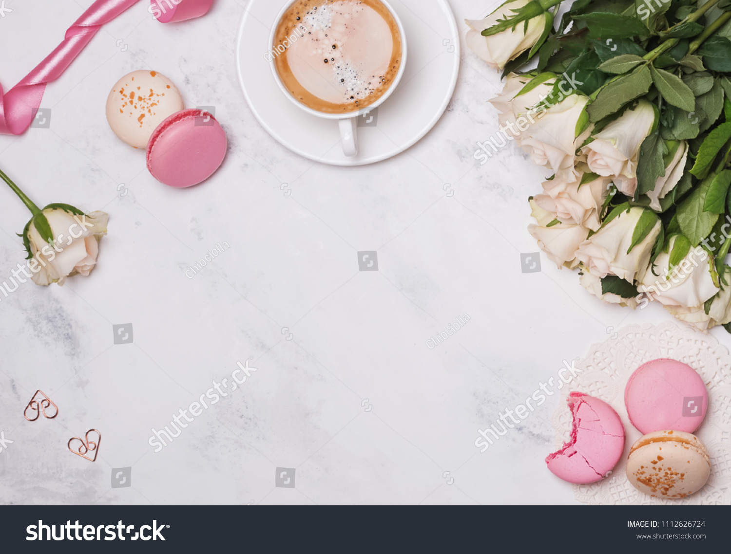 Stylish flat lay with macarons, coffee and roses #1112626724