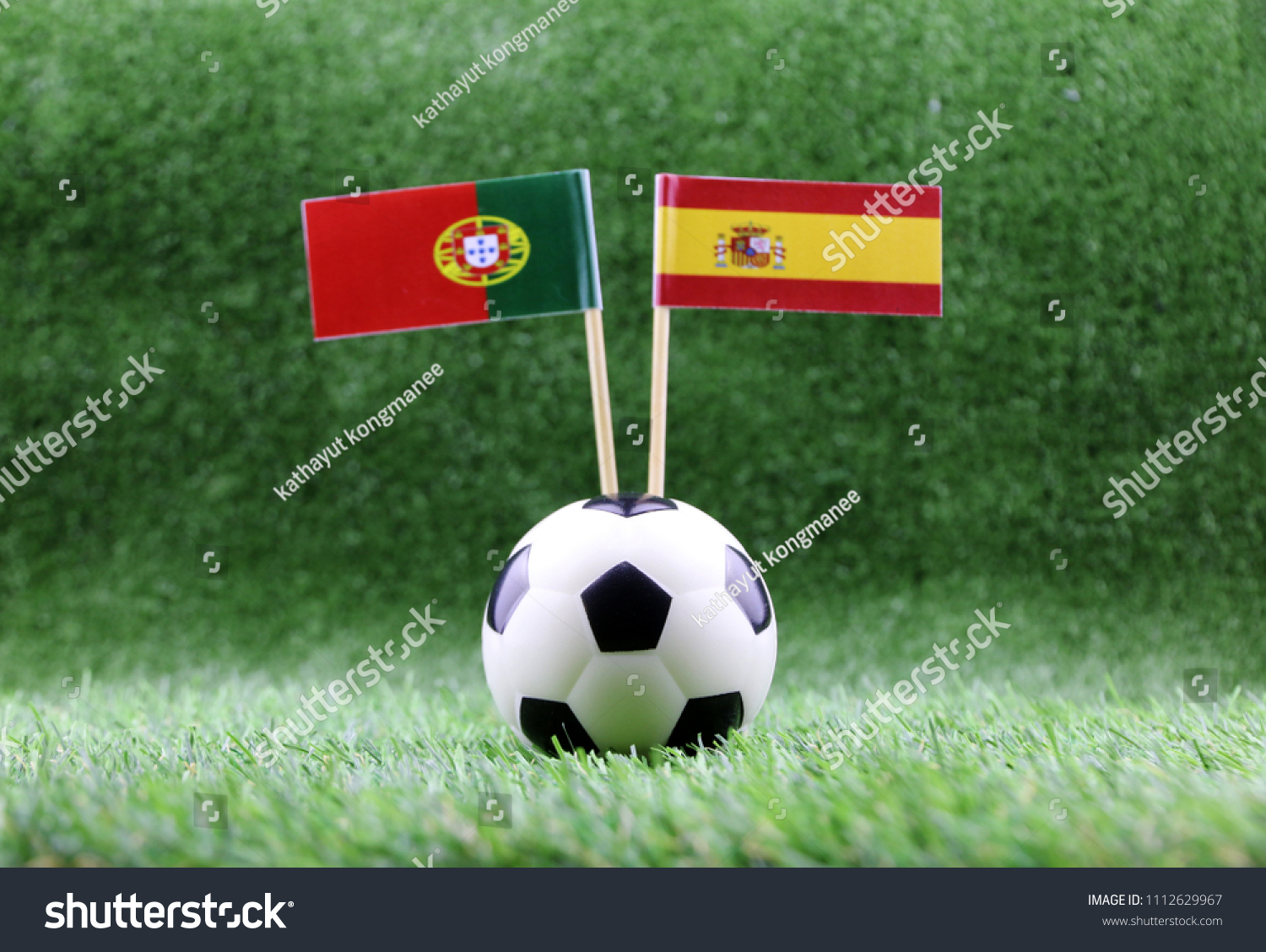 ball with Spain VS Portugal flag match on Green grass football 2018 #1112629967
