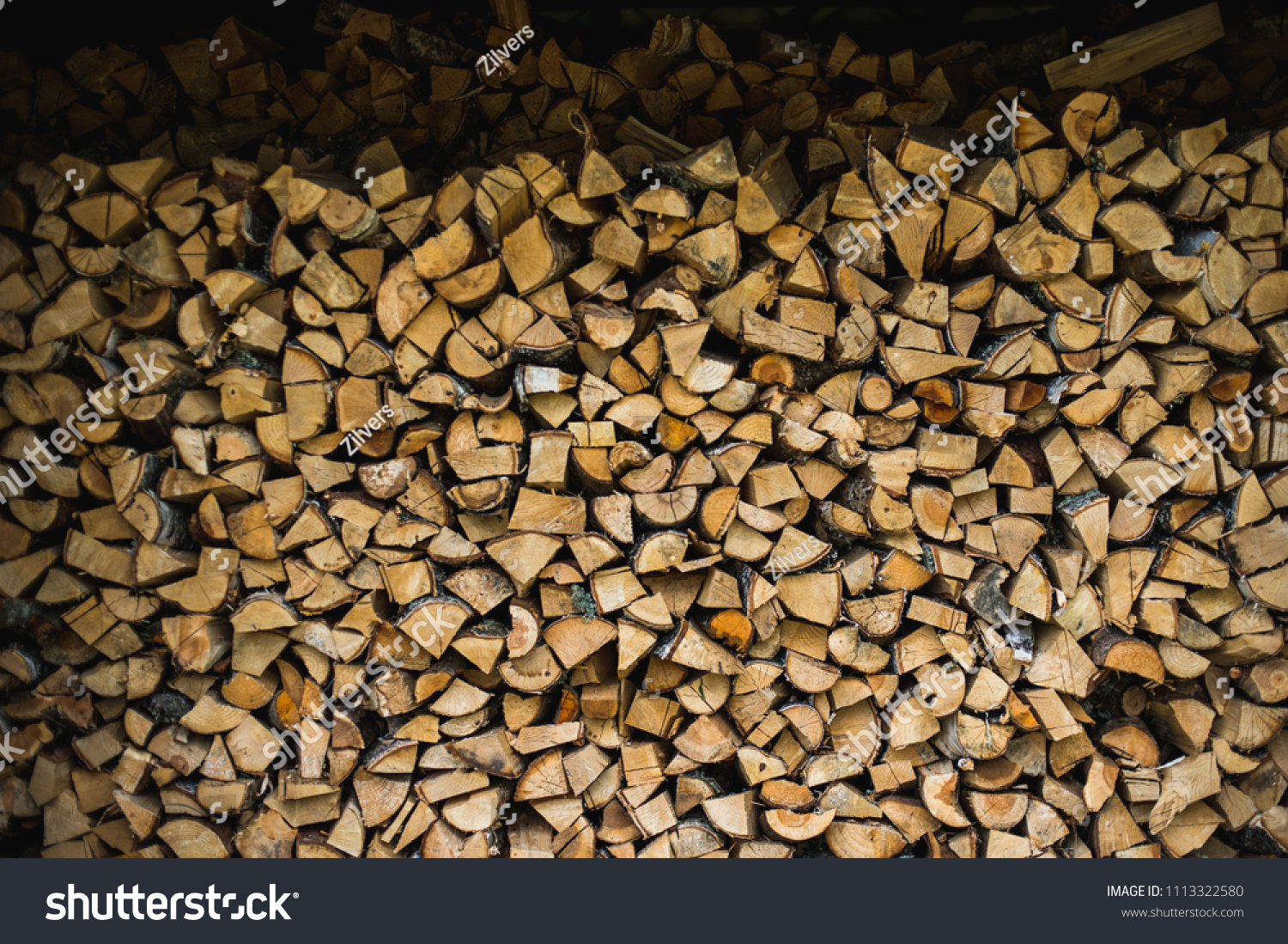Wooden background. Firewood for the winter, stacks of firewood #1113322580