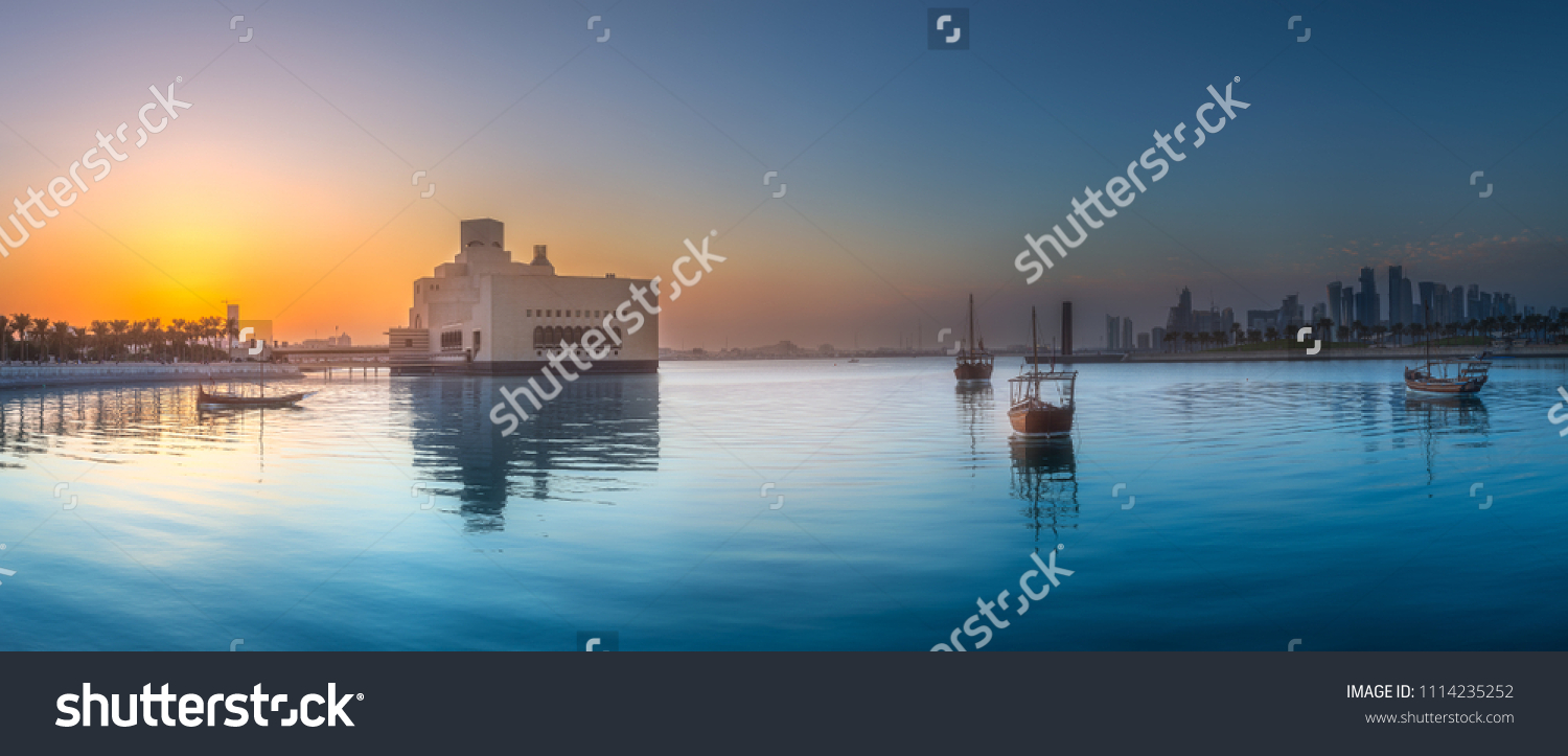 Seafront of Doha park and East Mound-Skyline view during purple sunset with boats, Qatar. #1114235252