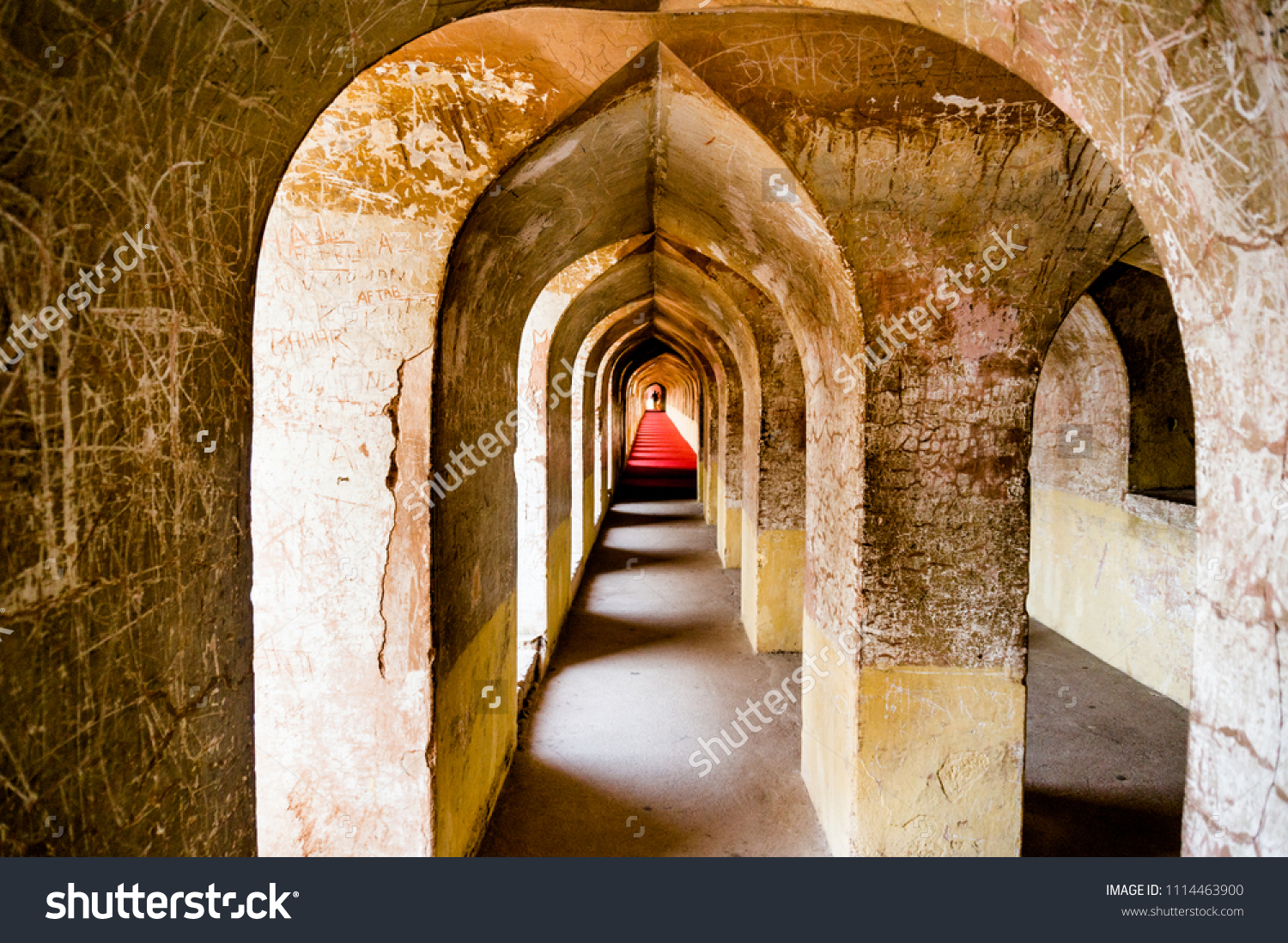 Arches and hallways of the bhool bhuliya maze that leads to the roof of the complex. This amazing architecture marvel prevents anyone without a guide from reaching the palace roof #1114463900