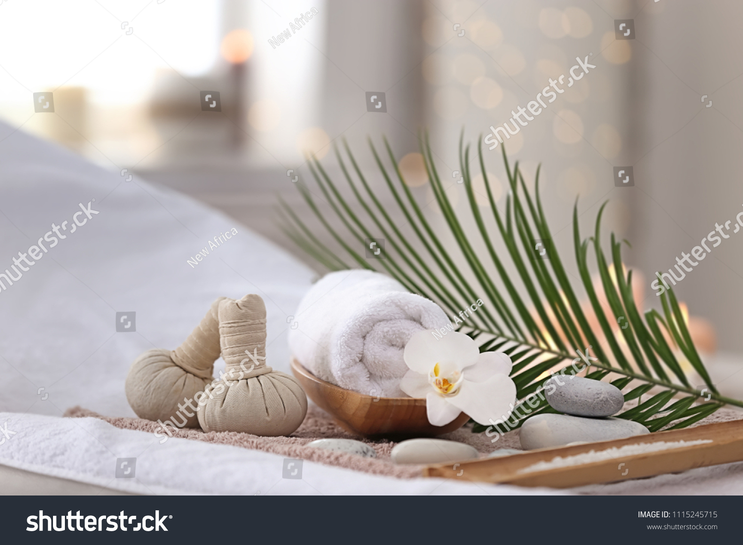 Beautiful spa composition on massage table in wellness center #1115245715