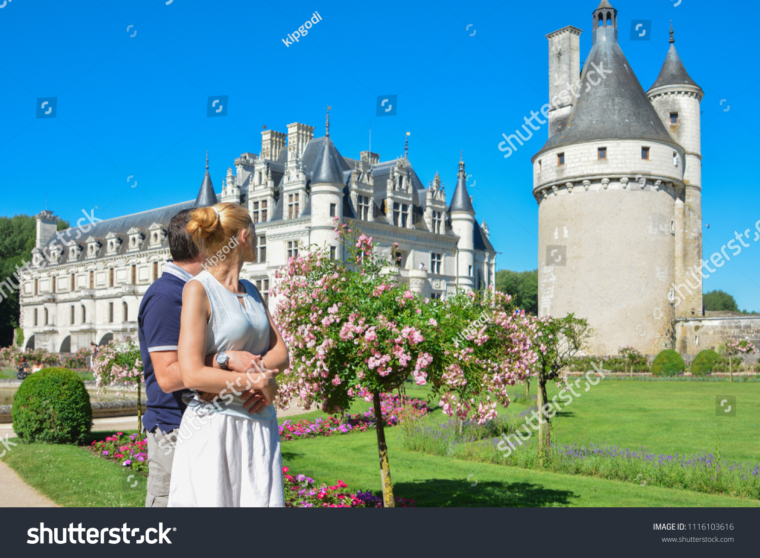 Man and woman looking at the castle Chenonceau Medieval Chateau in France #1116103616