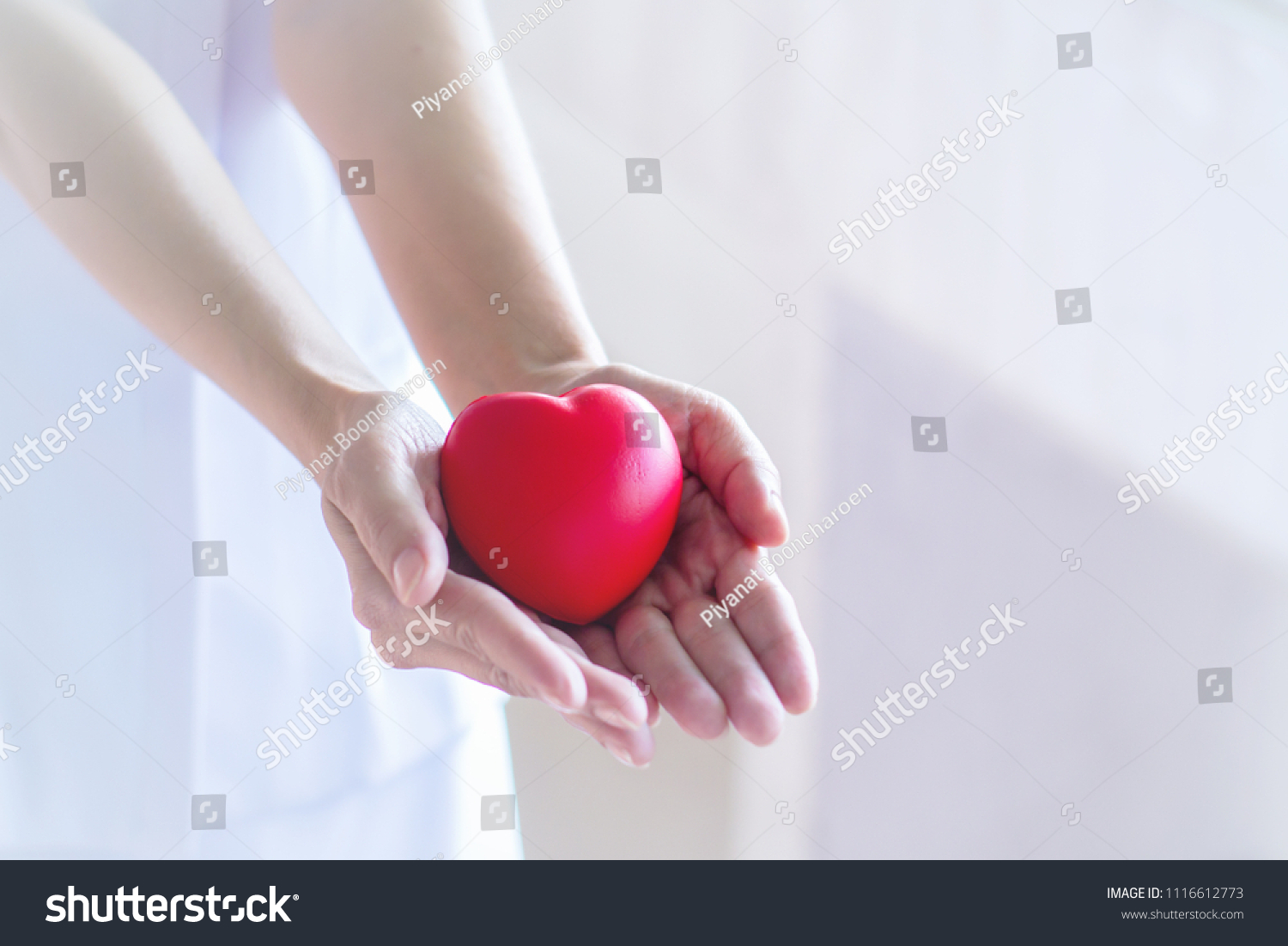 Closeup Nurse hands holding and giving red heart in hospital.healthy and healthcare concept with selective focus. #1116612773
