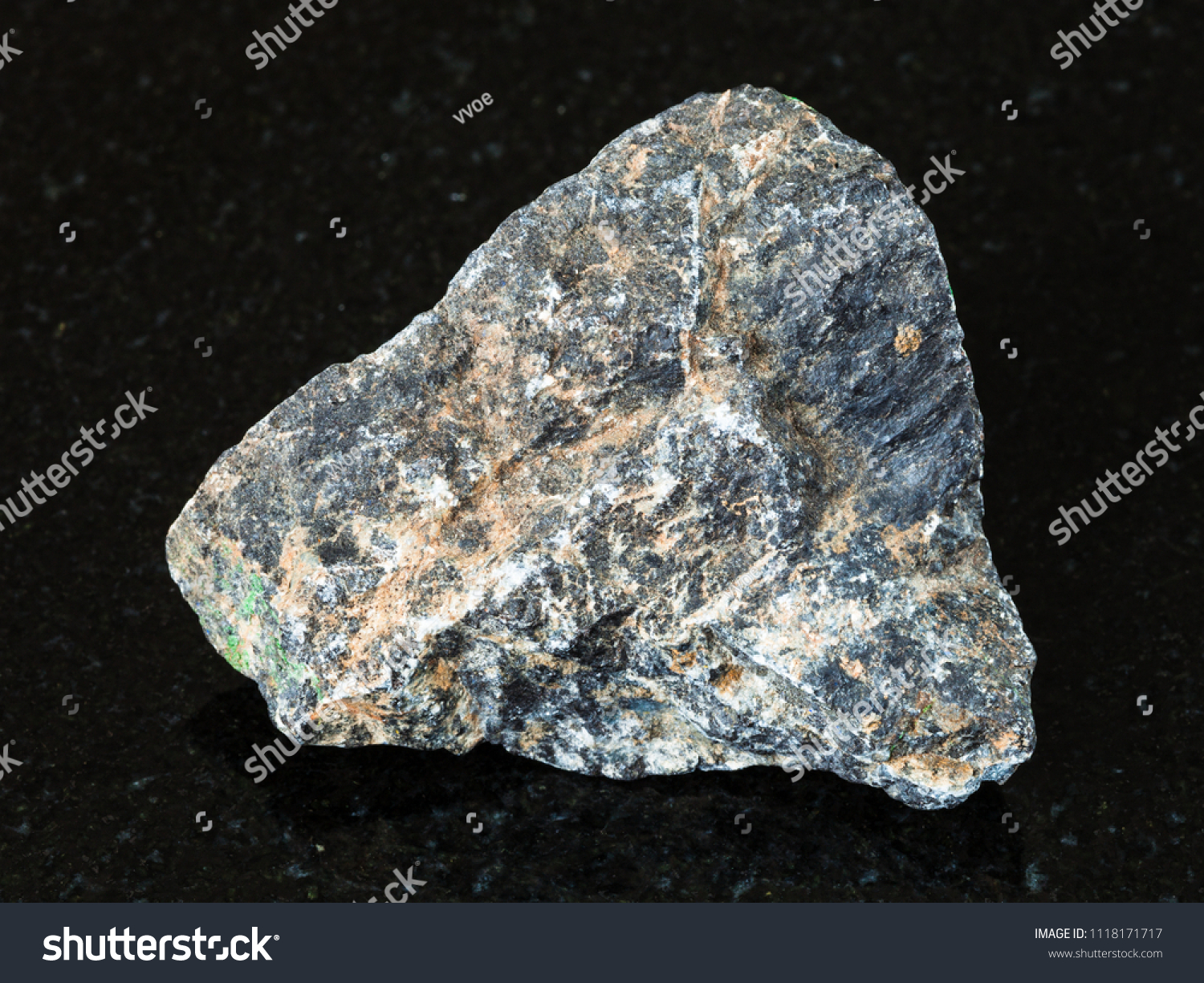 macro shooting of natural mineral - rough Chromite stone on black granite from Ural Mountains #1118171717
