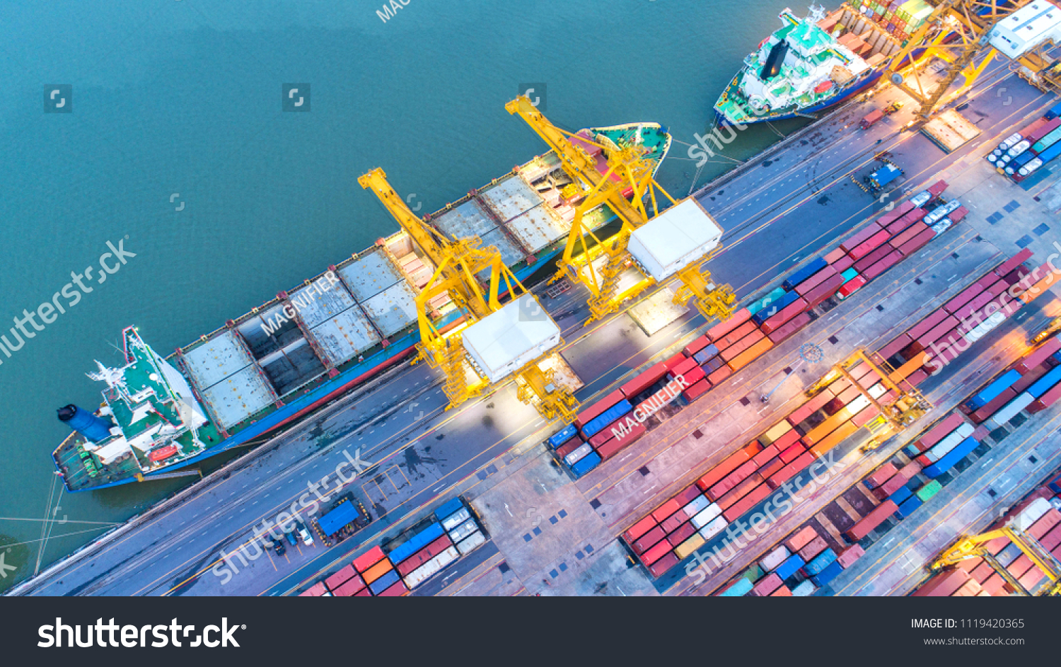 Container ship in export and import business and logistics. Shipping cargo to harbor by crane. Water transport International. Aerial view and top view. #1119420365