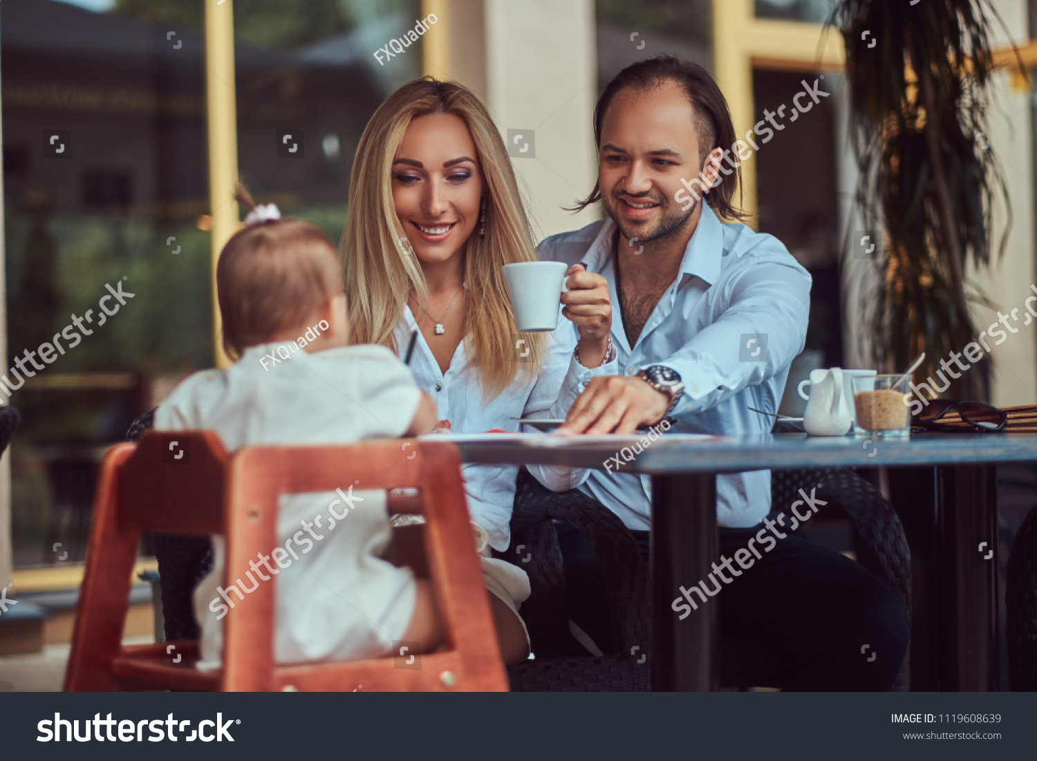 Family and people concept - happy mother, father and the little girl in outdoor cafe. #1119608639