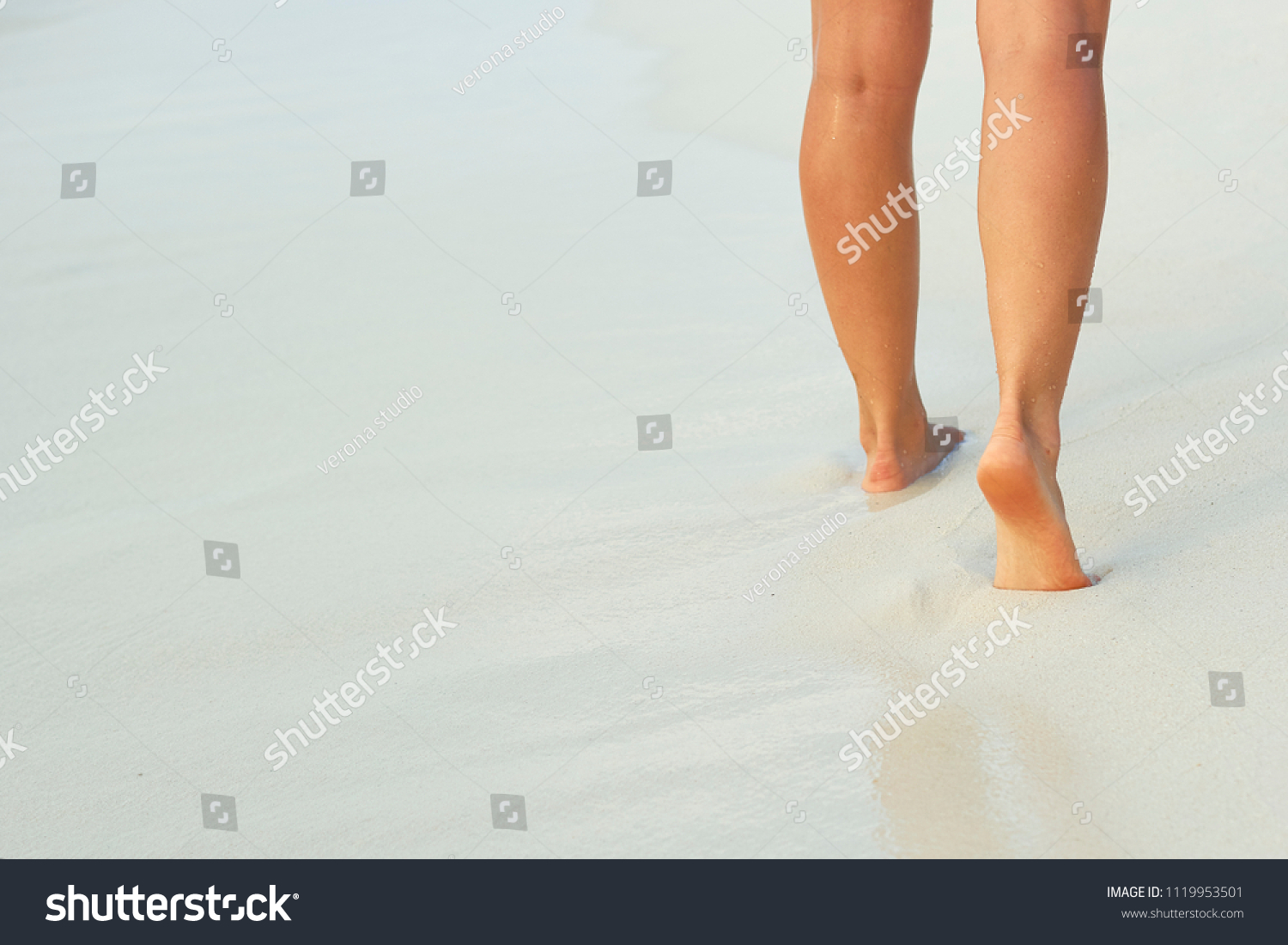 Сlose up of woman leg on the beach. Woman  feet walking on the sand. Foot female.Skin Care. #1119953501