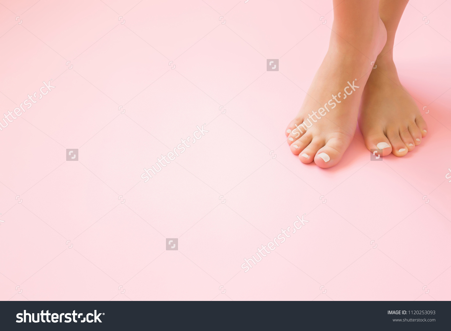 Young, perfect groomed woman's feet on pastel pink background. Care about nails and clean, soft, smooth body skin. Pedicure and manicure beauty salon. Copy space. Empty place for text or logo. #1120253093