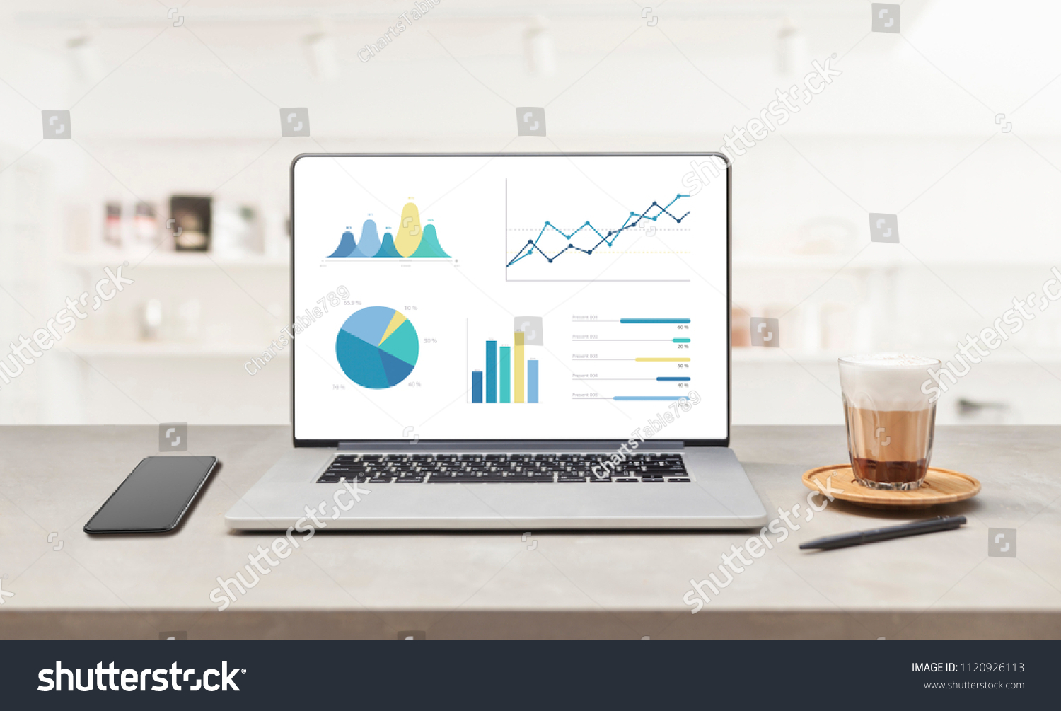 Laptop on wooden table showing charts and graph against white office room and windows background ,Analysis Business Accounting, Statistics Concept. #1120926113