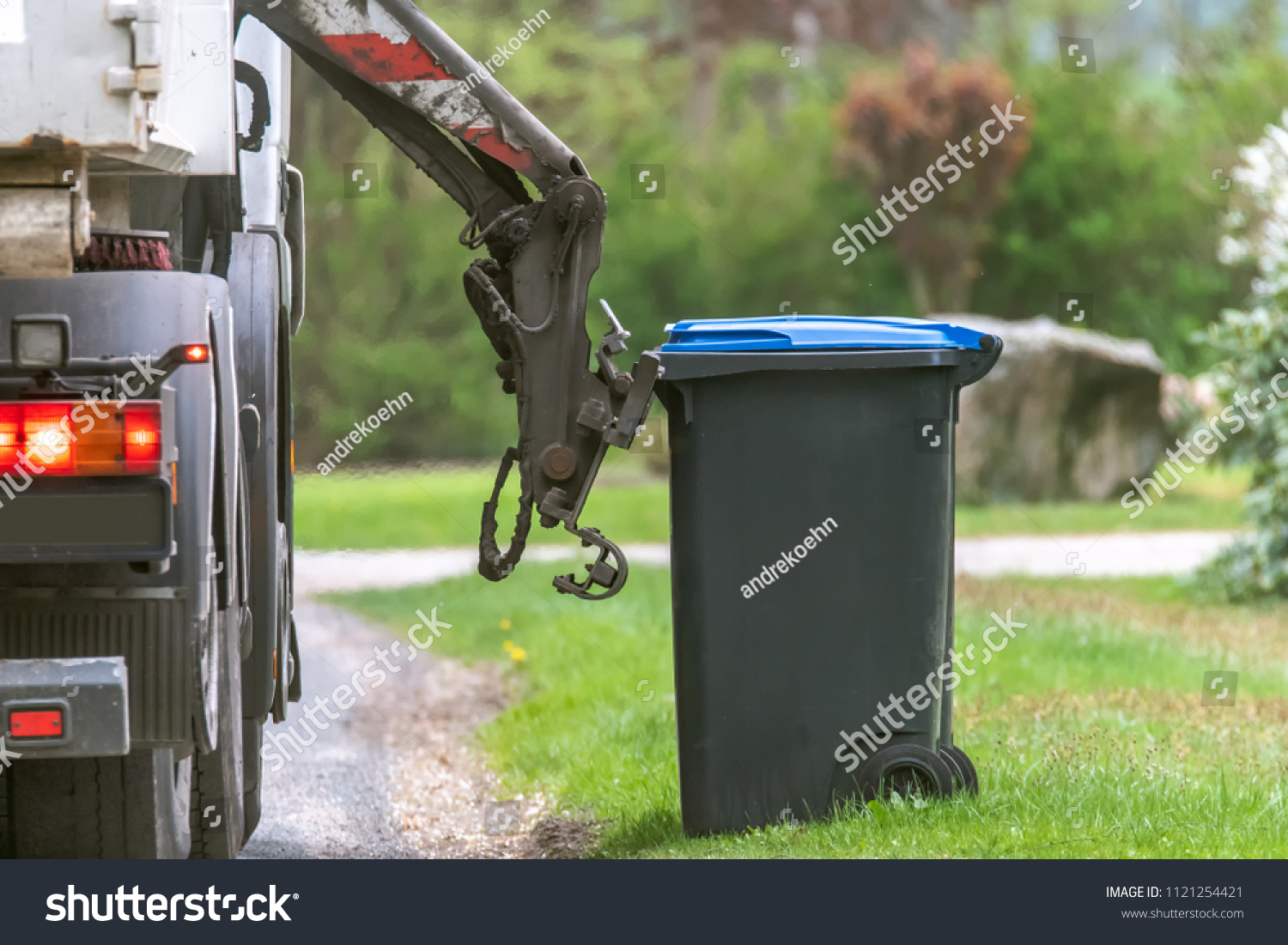 Municipal waste disposal. With a special car garbage truck, the garbage from the garbage bin is loaded into the car. Concept: Waste disposal and cleanliness #1121254421