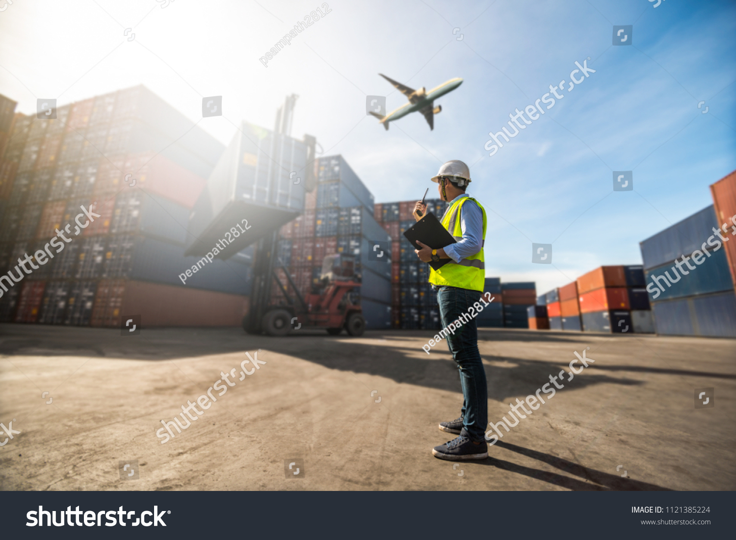 Foreman control loading Containers box to truck for Logistic Import Export Background, Business logistic concept, import and export concept
 #1121385224
