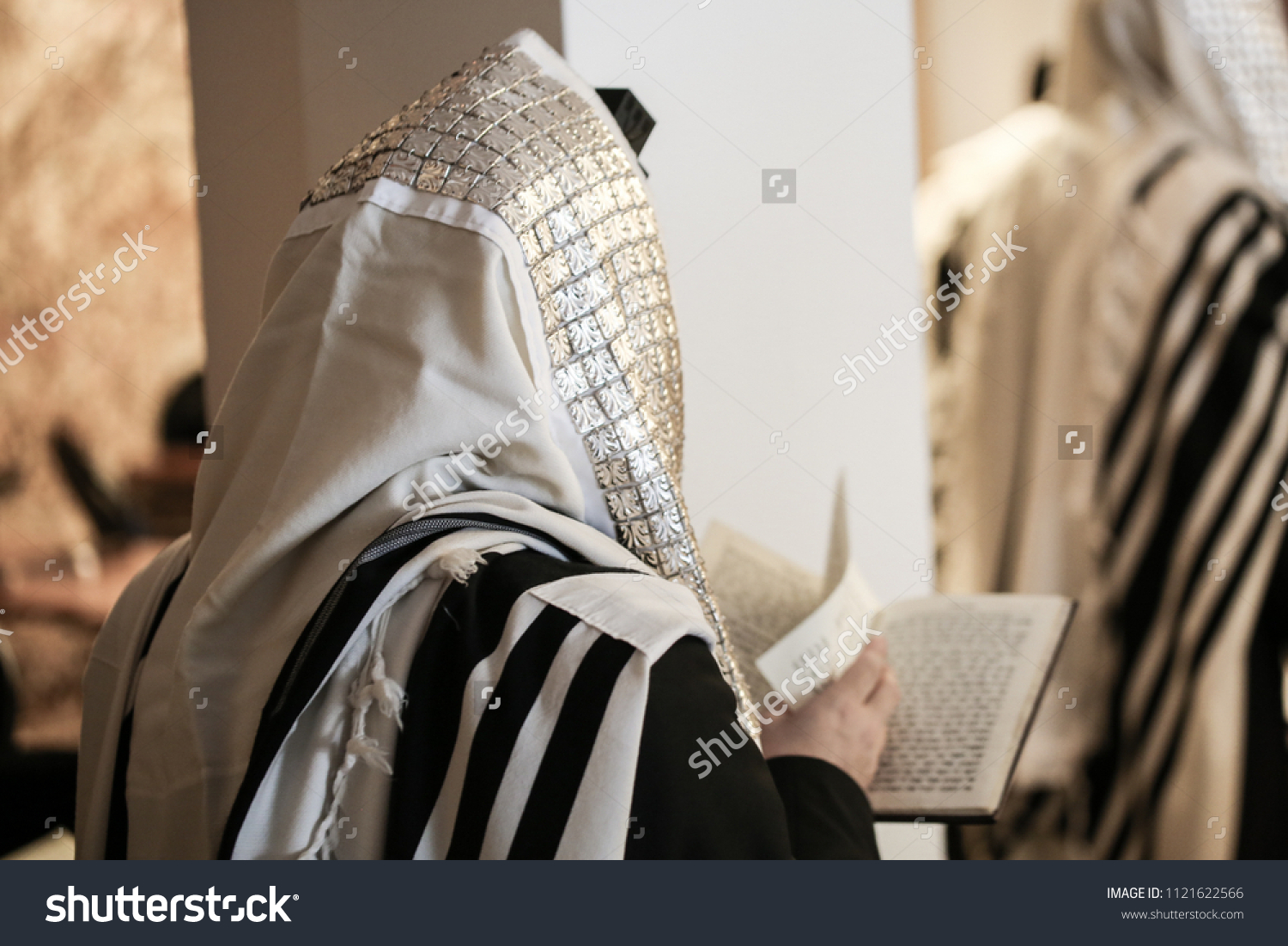Jewish orthodox man wrapped in prayer shawl from a side view #1121622566