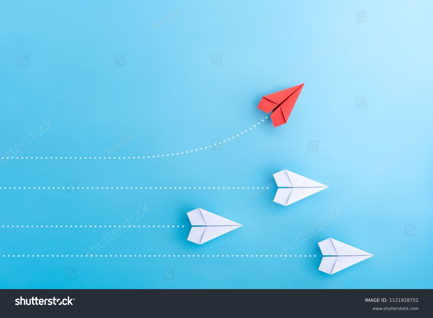 Group of paper plane in one direction and with one individual pointing in the different way. Business concept for new ideas creativity and innovative solution. #1121928752