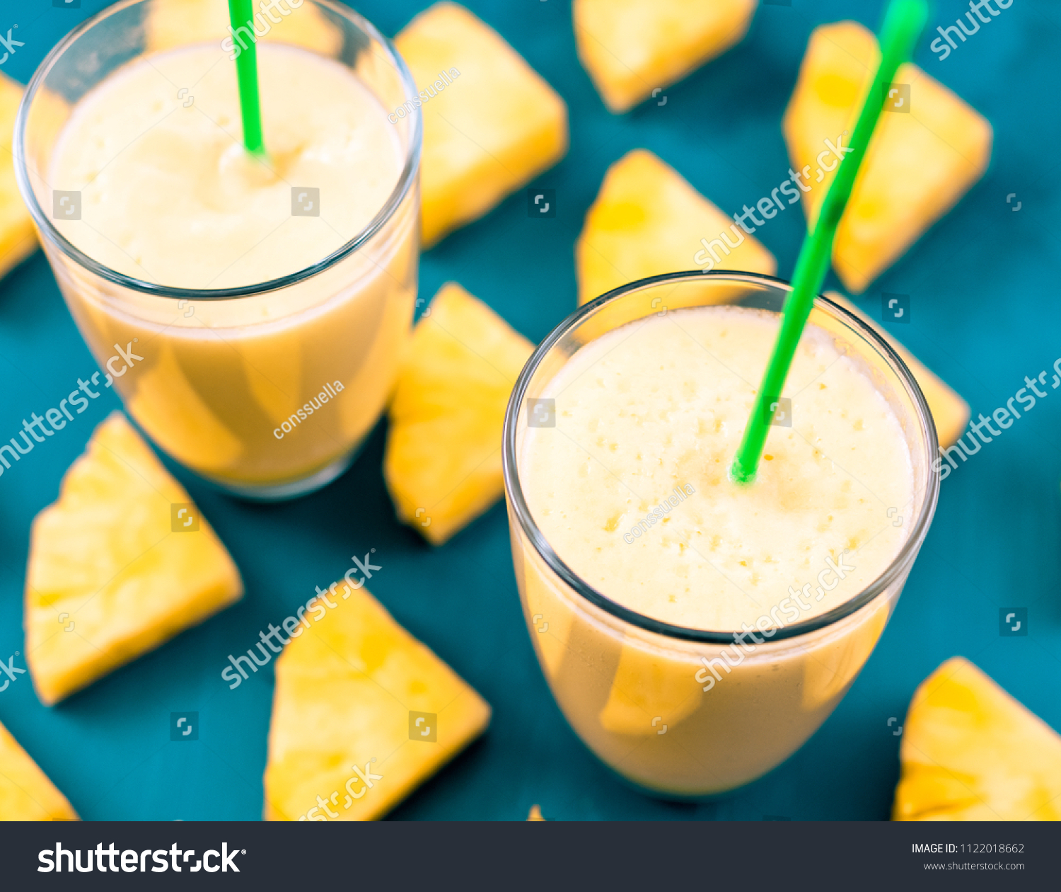 Pineapple smoothie with fresh pineapple on wooden blue table. #1122018662
