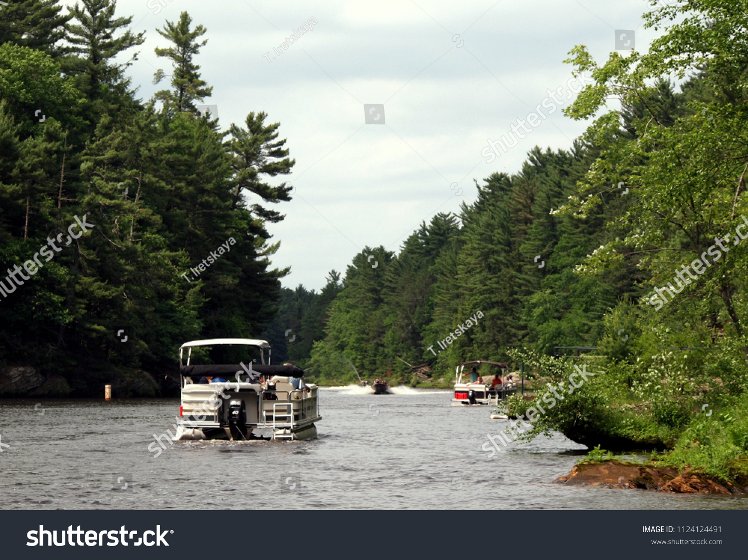 Boating at the Wisconsin river (USA) - Upper Dells part. Landscape and other recreational boats visible. #1124124491