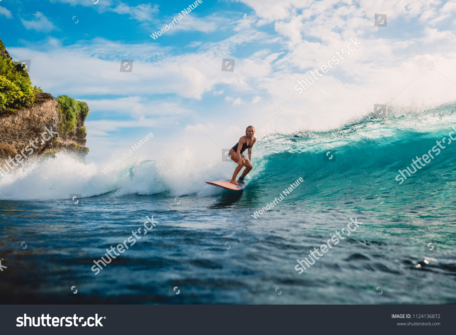 Surf girl on surfboard. Woman in ocean during surfing. Surfer and ocean wave #1124136872