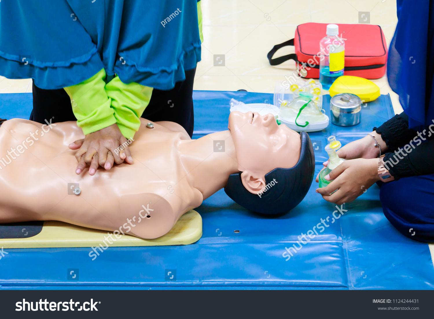 hand Heart pump with medical dummy on CPR, in emergency refresher training to assist of physician #1124244431