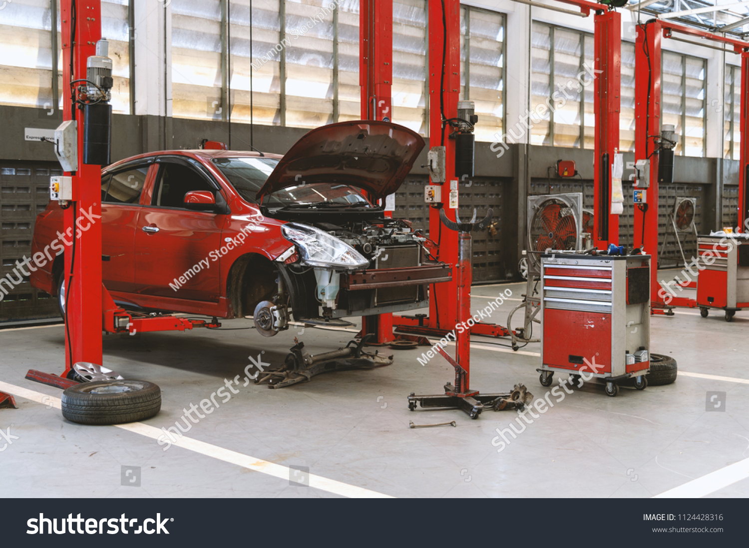 car repair station with soft-focus and over light in the background #1124428316