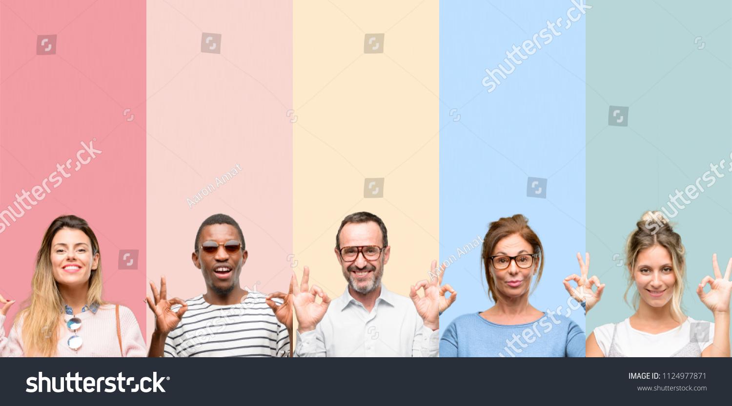 Mixed group of people, women and men doing ok sign gesture with both hands expressing meditation and relaxation #1124977871