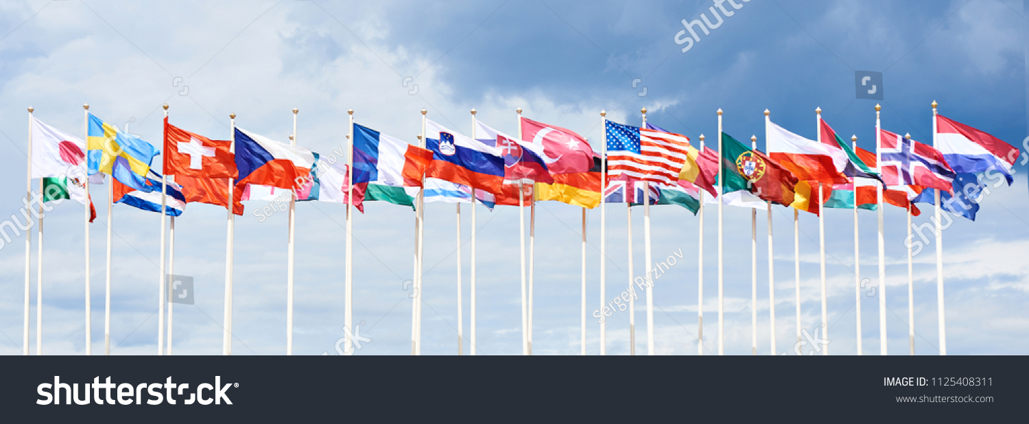 Flags of different countries on high flagpoles #1125408311