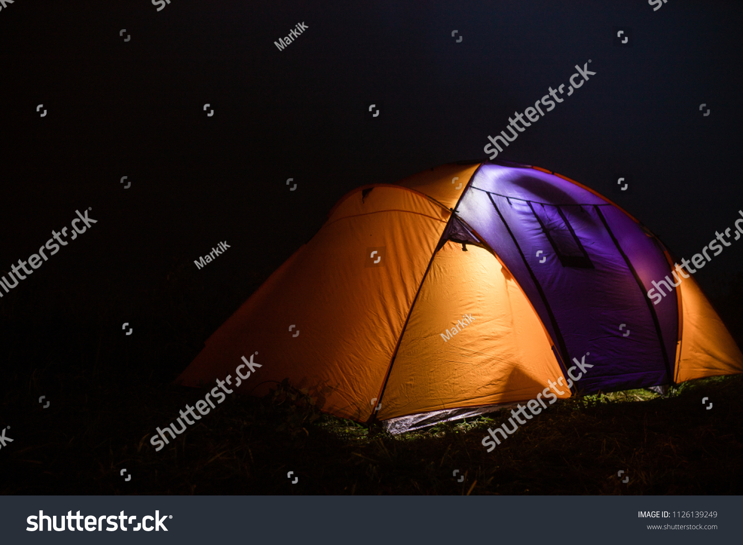 tourism, travel, tourism, tourism and the concept of active people's they, creating a tent in the open air. to collect a tent in nature.
Camping and tent under a pine forest at sunset. #1126139249