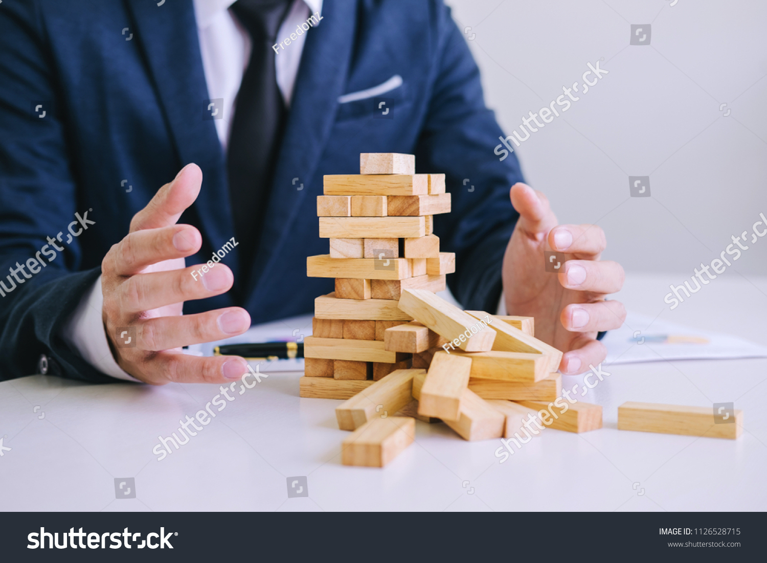 Alternative risk concept, plan and strategy in business protect with balance wooden stack with hand control risk shape. #1126528715